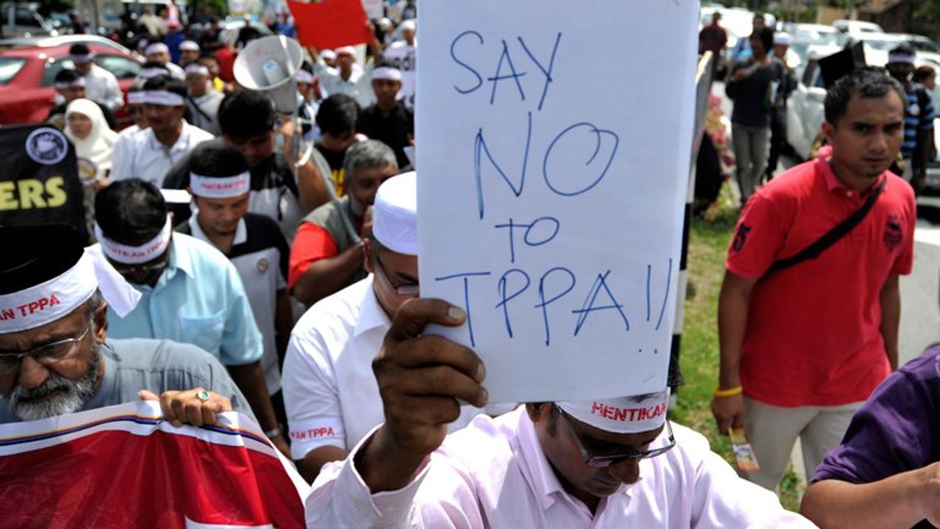 Demonstrators march during a protest against Malaysia's participation in negotiations for a huge trans-Pacific trade deal (TPP), in Kuala Lumpur, on July 19, 2013. Local activists have staged several protests against the deal, fearing it will compromise the country's sovereignty and calling on the government to disclose details on the agreement.