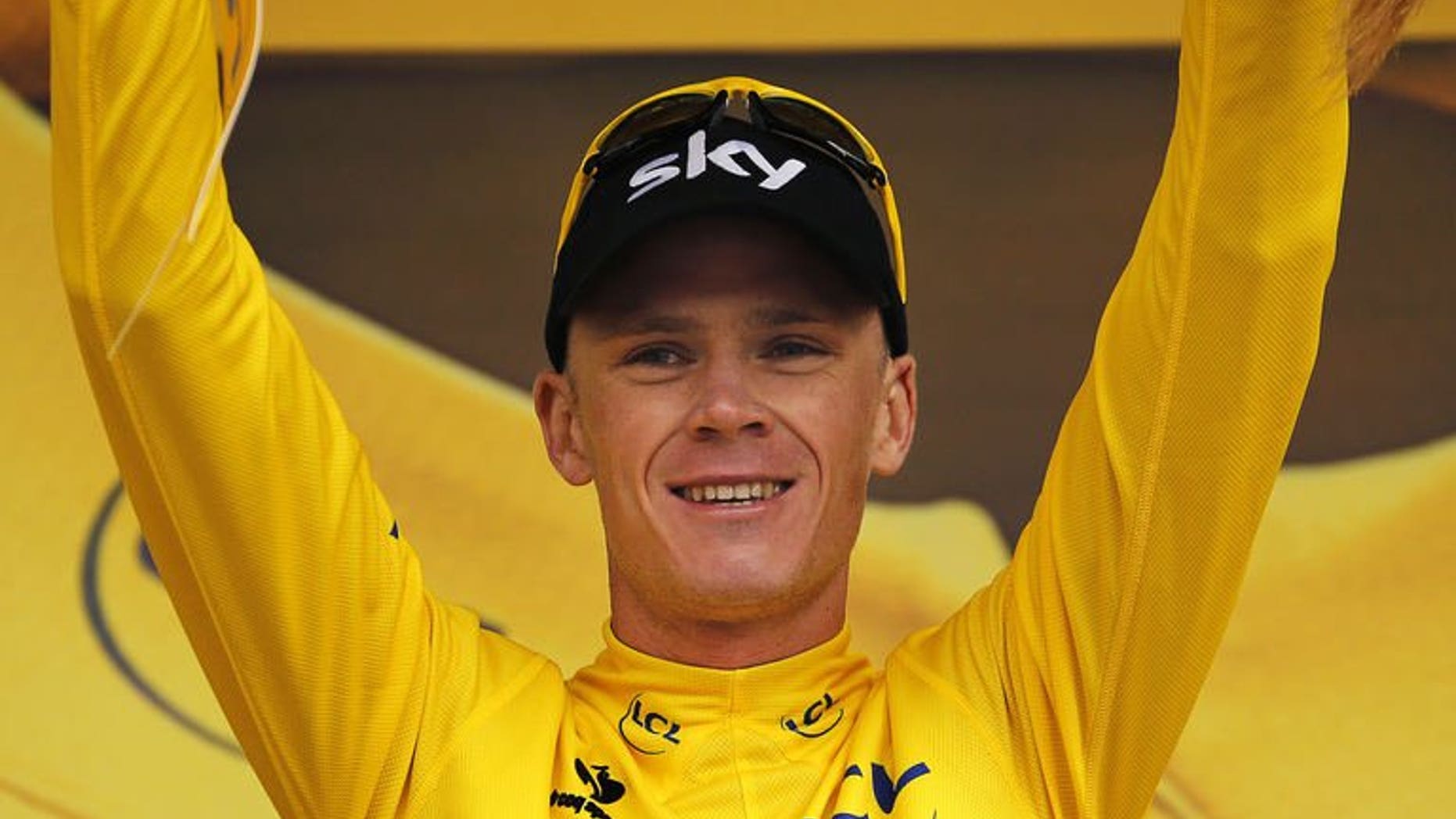 Britain's Christopher Froome celebrates his overall leader yellow jersey on the podium at the end of the 19th stage of the 100th edition of the Tour de France on July 19, 2013 between Bourg-d'Oisans and Le Grand-Bornand, French Alps.
