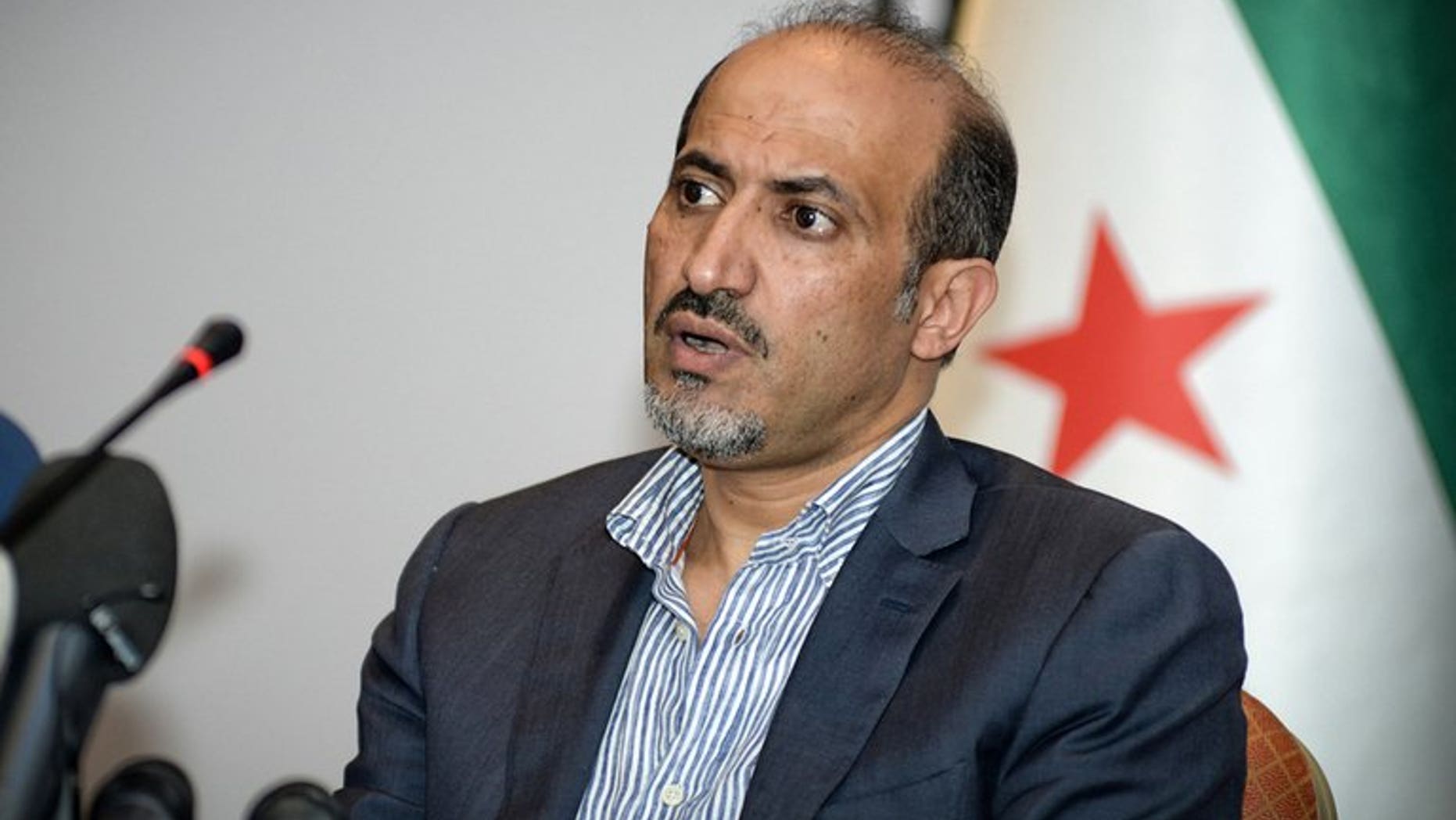 A handout photo taken and provided on July 9, 2013 shows Syrian National Coalition (SNC) leader Ahmad al-Assi attending a meeting in Istanbul. Jarba has set his priority on securing arms for rebels fighting regime troops since 2011.