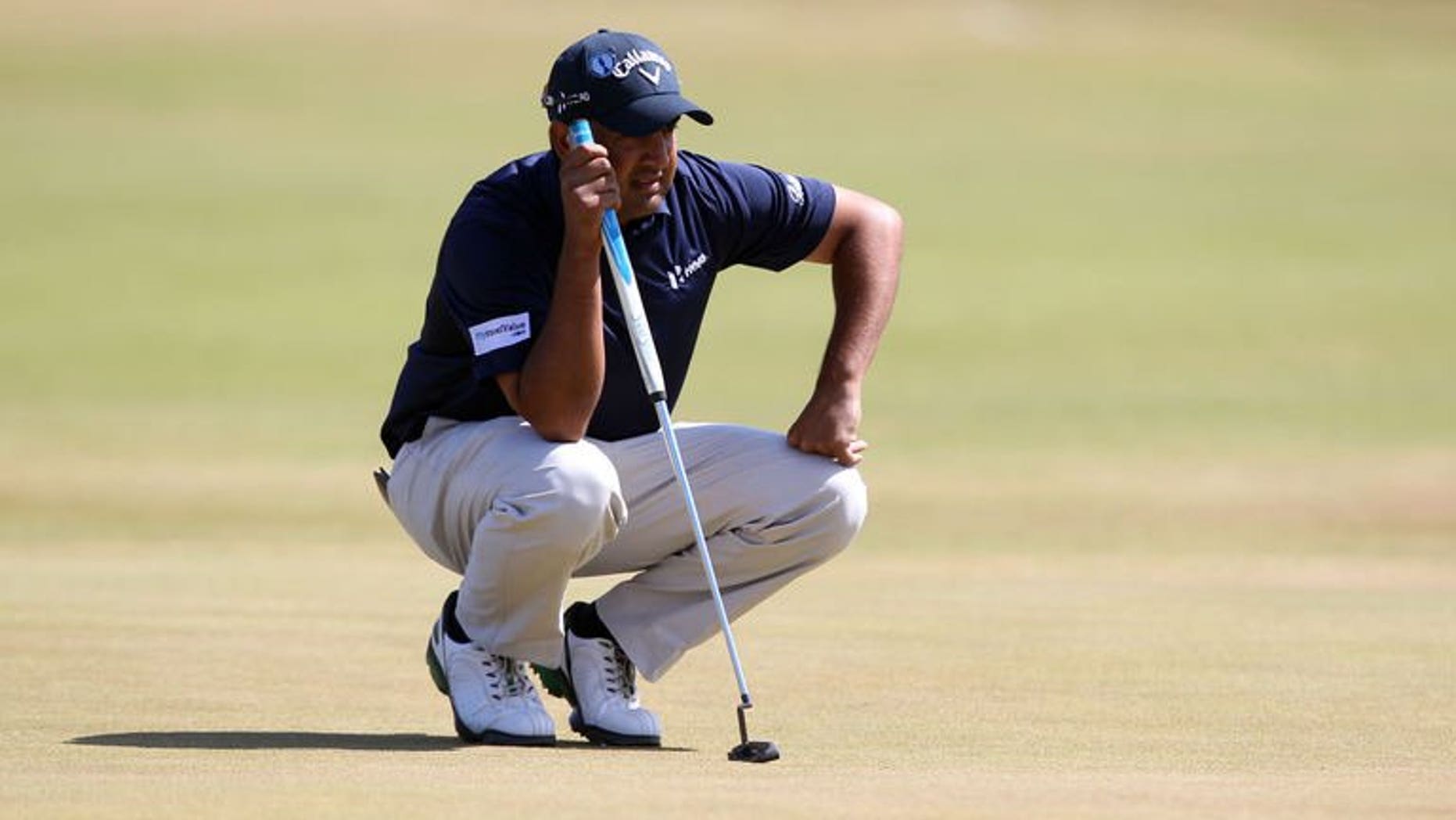 India's Shiv Kapur lines up a putt on the first green during the third round of the 2013 British Open Golf Championship at Muirfield golf course at Gullane in Scotland on July 20, 2013.