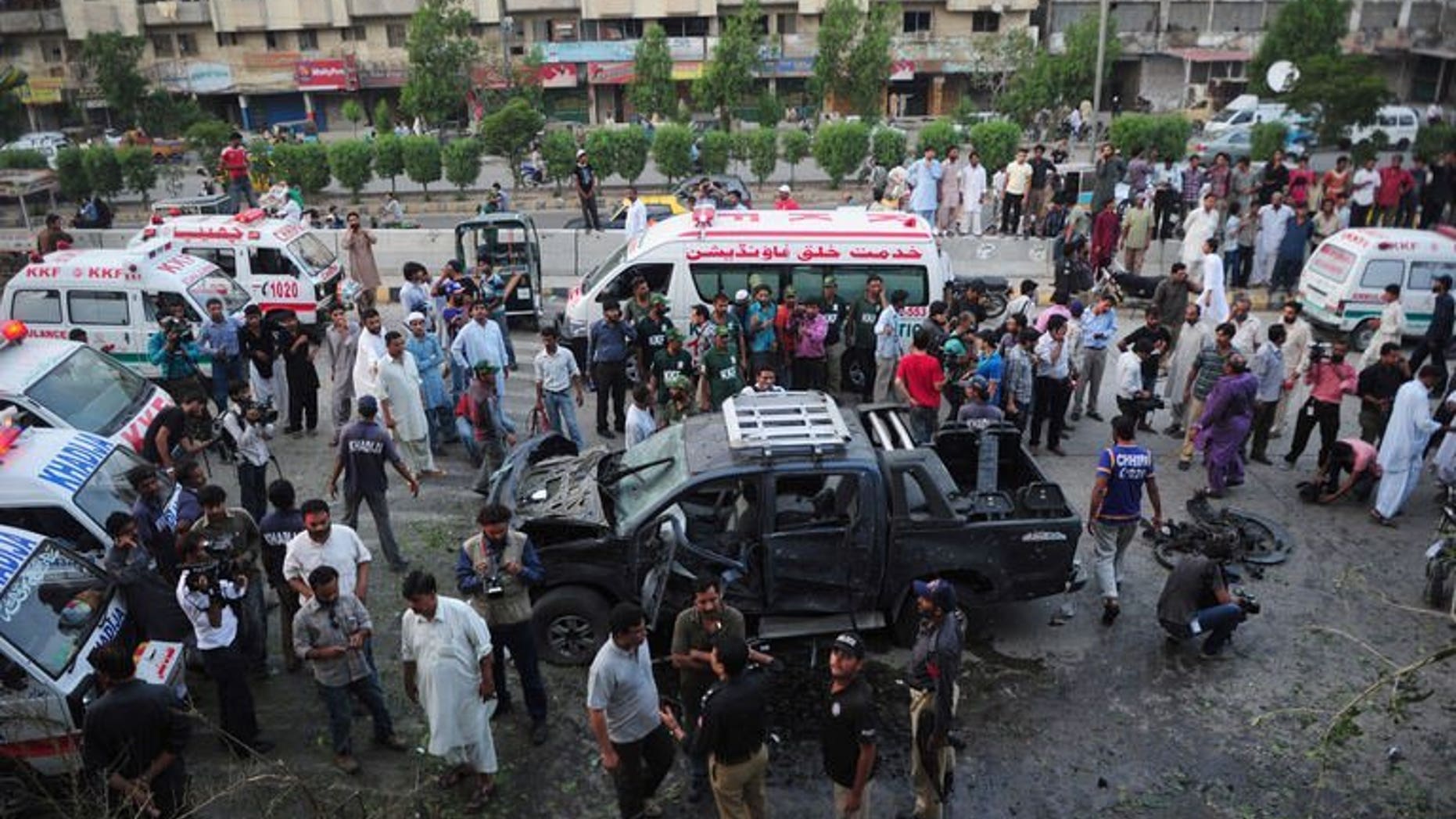 Pakistani security personnel collect evidence at the site of a bomb attack in Karachi on July 20, 2013. Two separate bomb explosions late Saturday killed four people and wounded seven others in Pakistan's port city Karachi, police said.