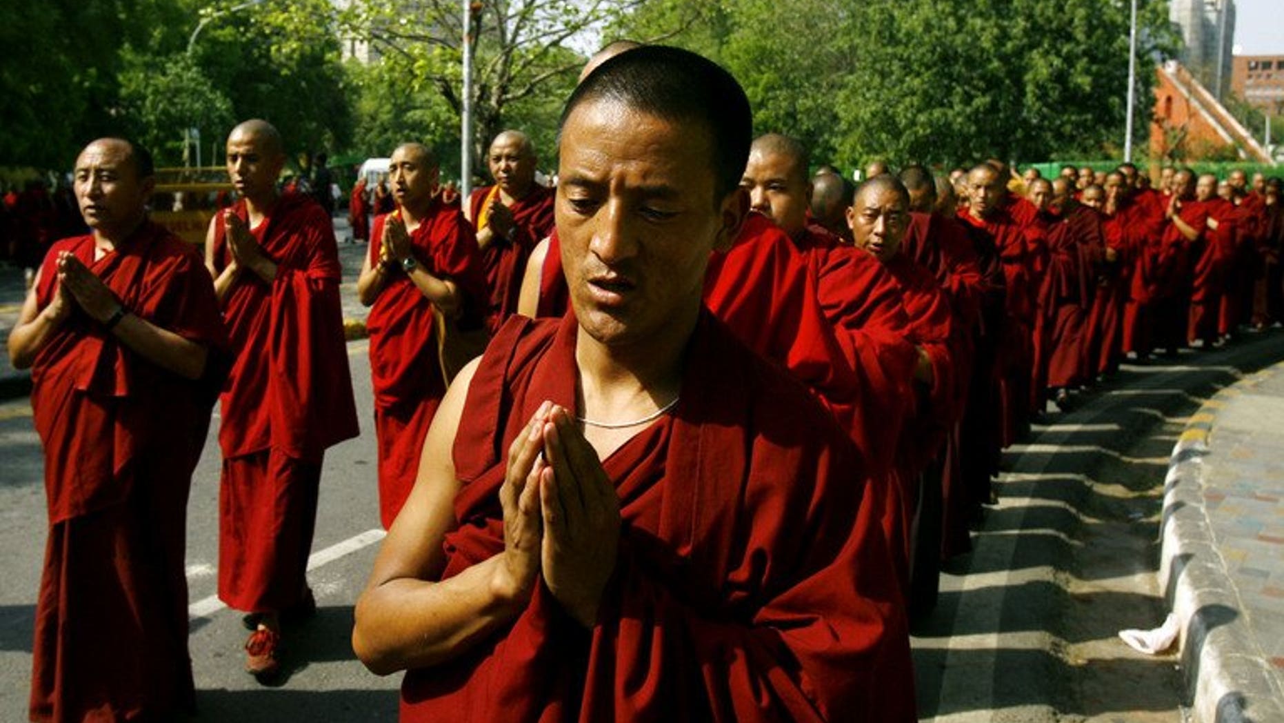 This file photo shows Tibetan monks in exile praying during a protest against alleged human rights violations in their home-land, in New Delhi, on April 11, 2008. A Tibetan monk died on Saturday, after setting himself on fire in southwest China, in the first such protest for more than a month.