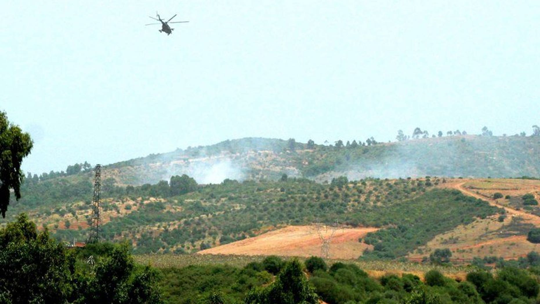 An Algerian army helicopter flies over a zone where troops gfought Islamists in Kabyle zone, east of Algiers August 29, 2007.