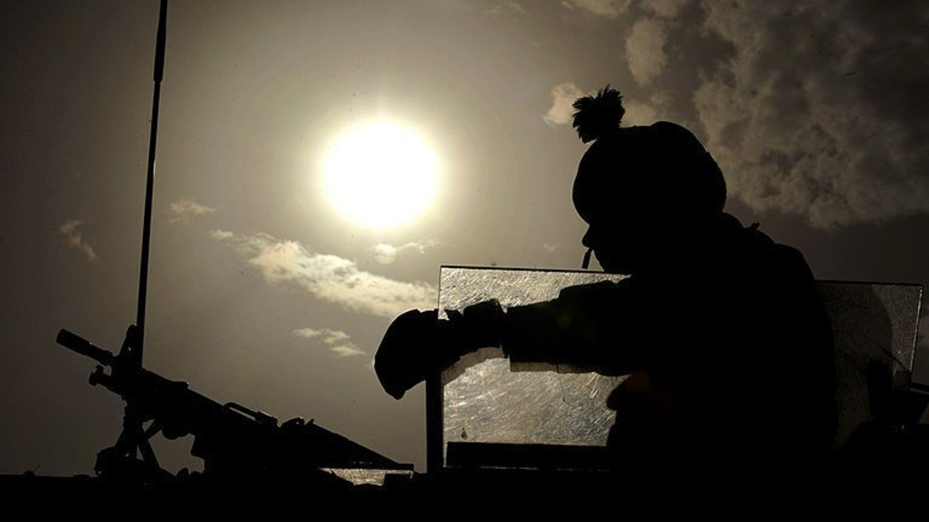 A British soldier keeps watch during a patrol on the outskirts of Kabul, on July 27, 2008. A UN demining group has warned that unexploded ordnance left behind by NATO troops is killing and injuring a rising number of Afghan civilians.