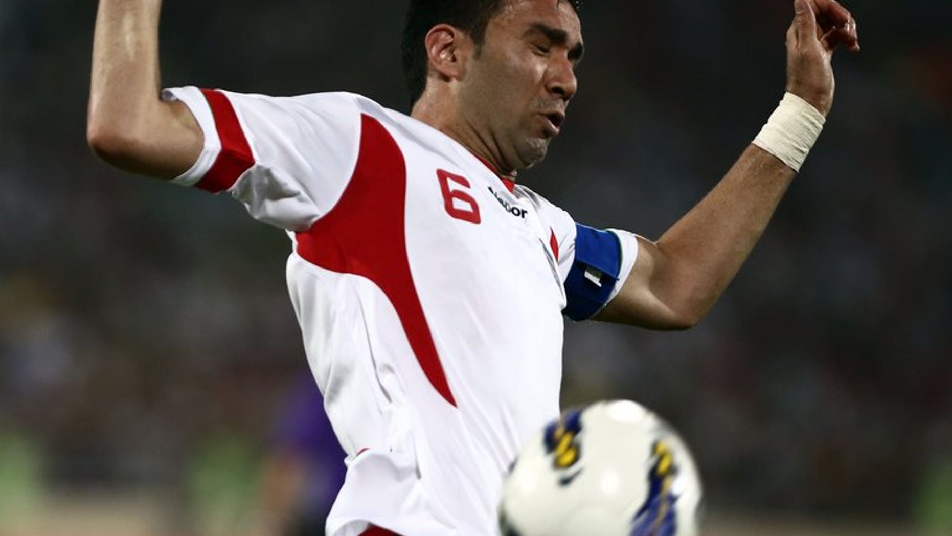 Iran's Javad Nekounam controls the ball during their 2014 World Cup qualifying match against Lebanon in Tehran, on June 11, 2013. Iran has barred Nekounam's lucrative transfer to a club in neighbouring UAE because of a dispute over a name, media reports said on Sunday.