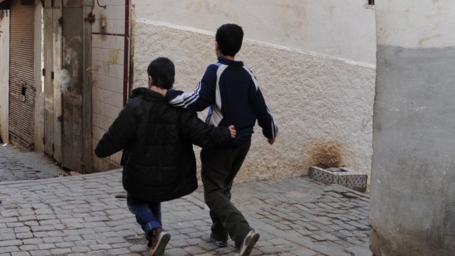 Children walk in a narrow street of the Kasbah of Algiers on March 22, 2013, in Algeria. The country's public prosecutor on Sunday demanded the death penalty for two men on trial for abducting and murdering two boys aged nine and 10, the news agency APS reported.