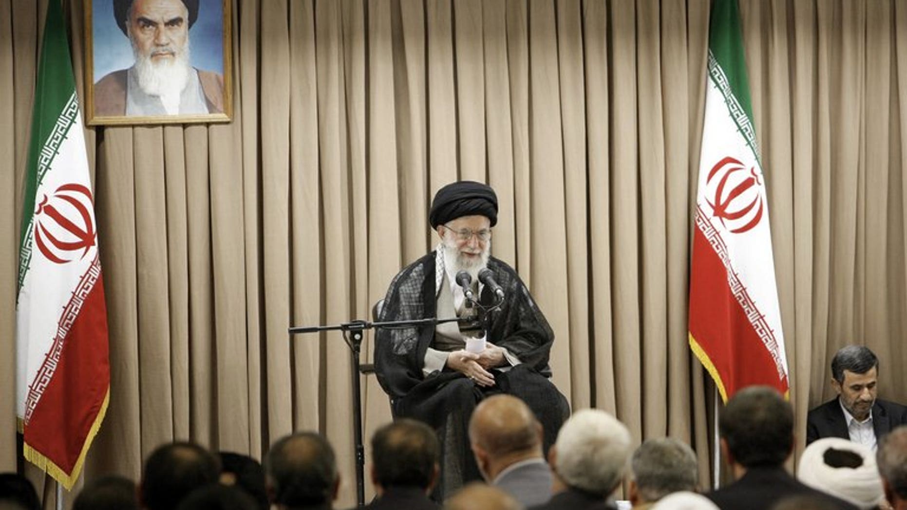 A picture released by the website of Iranian supreme leader Ayatollah Ali Khamenei (C) shows him speaking at a meeting with Iranian officials in the presence of outgoing President Mahmoud Ahmadinejad (R) in Tehran on July 21, 2013. Khamenei warned that Washington was "not trustworthy", after former US officials and lawmakers urged diplomacy with the Islamic republic's incoming president.