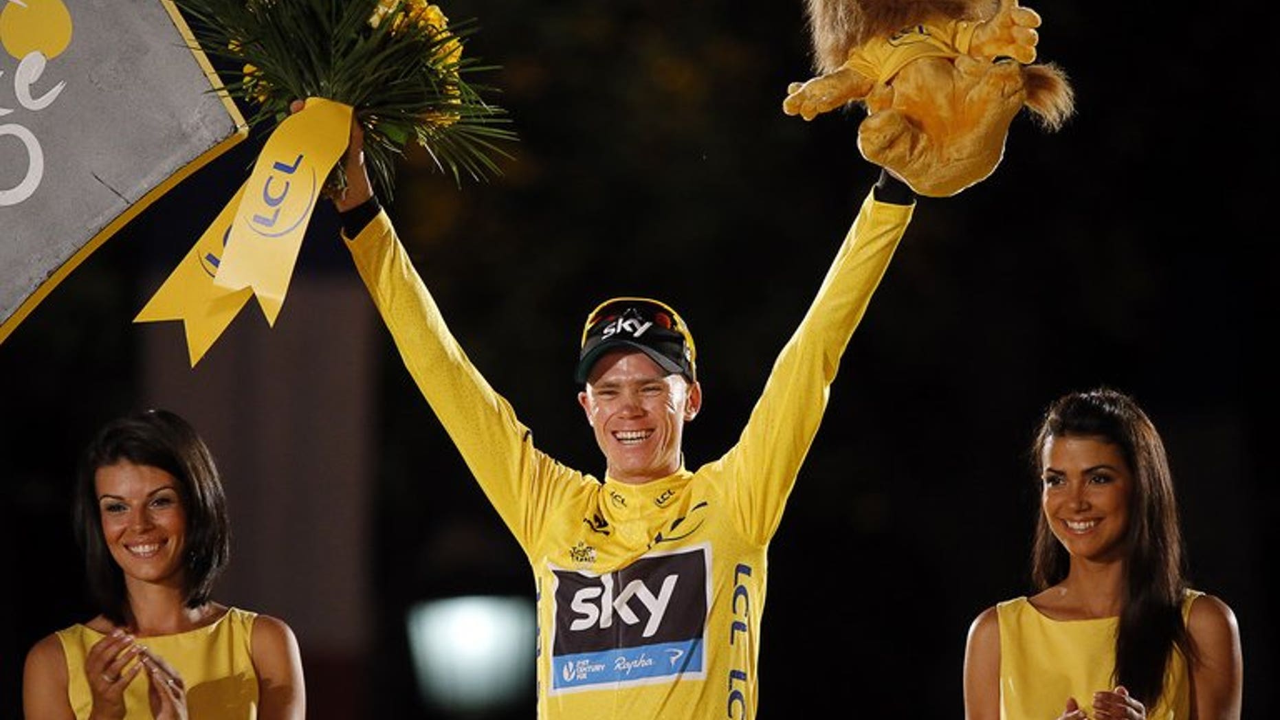 Tour de France 2013 winner Britain's Chris Froome poses on the podium in Paris on the Champs-Elysee avenue, at the end of the 133.5 km twenty-first and last stage of the 100th edition of the Tour de France cycling race on July 21, 2013 between Versailles and Paris.