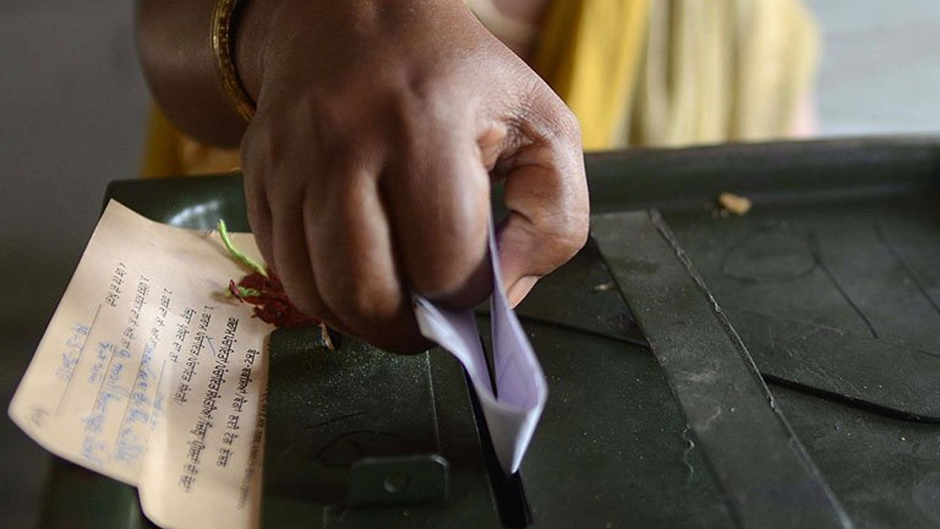 An Indian voter casts her ballot at a polling station in the village Meera Kot, on the outskirts of Amritsar, on May 19, 2013. India's top law officer has called for a ban on opinion polls during campaigning in next year's general election in the world's largest democracy, according to a report in the Hindustan Times.