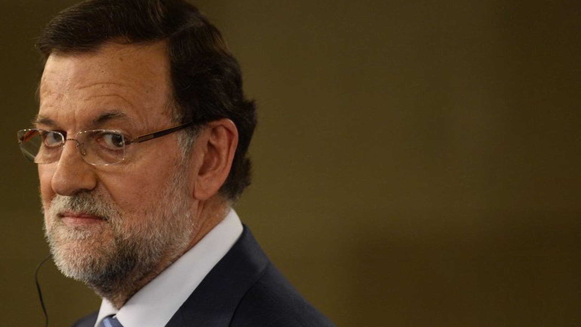 Spanish Prime Minister Mariano Rajoy looks on during a press conference in Madrid, on July 22, 2013. Rajoy, under fire over a corruption scandal, says he will appear in parliament in the coming days to explain the political situation of the country.
