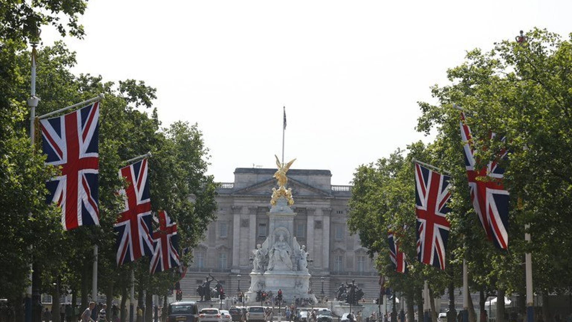 Britain's Union flags fly on the Mall leading to Buckingham Palace (background) in central London, on July 22, 2013. Prince William's wife Kate on Monday gave birth to a baby boy who will one day be heir to the British throne, Kensington Palace said in a statement.