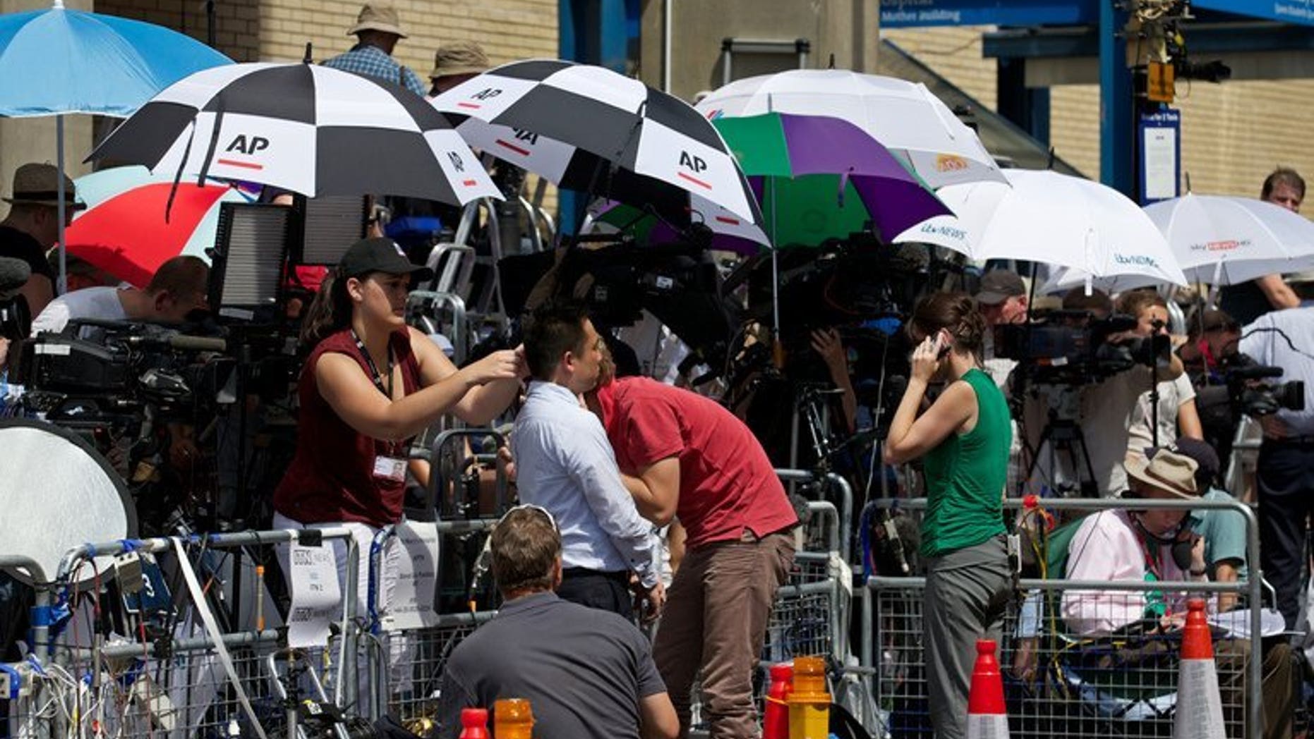 Media gather outside St Mary's hospital, on July 22, 2013. The Sun on Tuesday changed its name to "The Son" to honour the arrival of a baby boy for Prince William and Kate