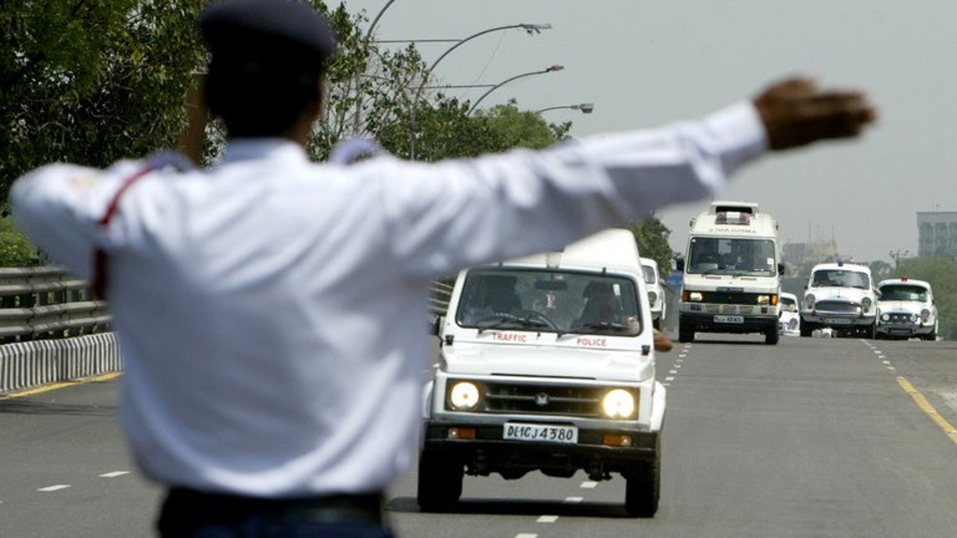 An Indian policeman directs traffic after a road accident in New Delhi, April 8, 2007. Two road accidents have killed at least 28 people in the southern Indian state of Karnataka.
