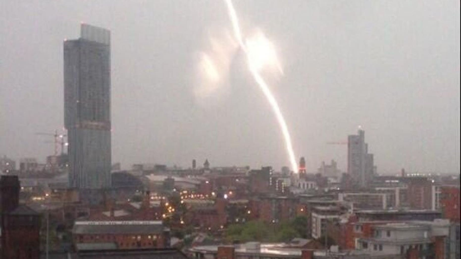 A screen grab from a video taken early on July 23, 2013 shows a lightning strike near Manchester Piccadilly train station in Manchester, north-west England. Lightning strikes and flooding caused severe delays for commuters on several mainline rail services across England and Scotland early on Tuesday.