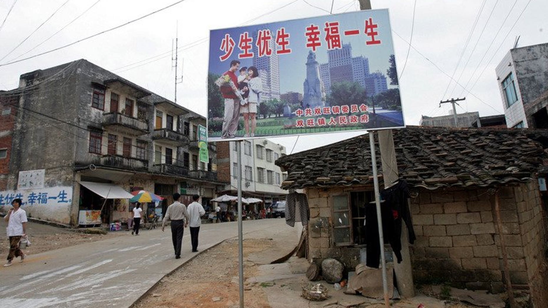 A Chinese "one-child" policy billboard saying, "Have less children, have a better life" greets residents in Shuangwang, Guangxi region, on May 25, 2007. A knife-wielding man has stormed an office enforcing China's one-child policy, stabbing two officials to death and injuring four people after a row over his offspring.