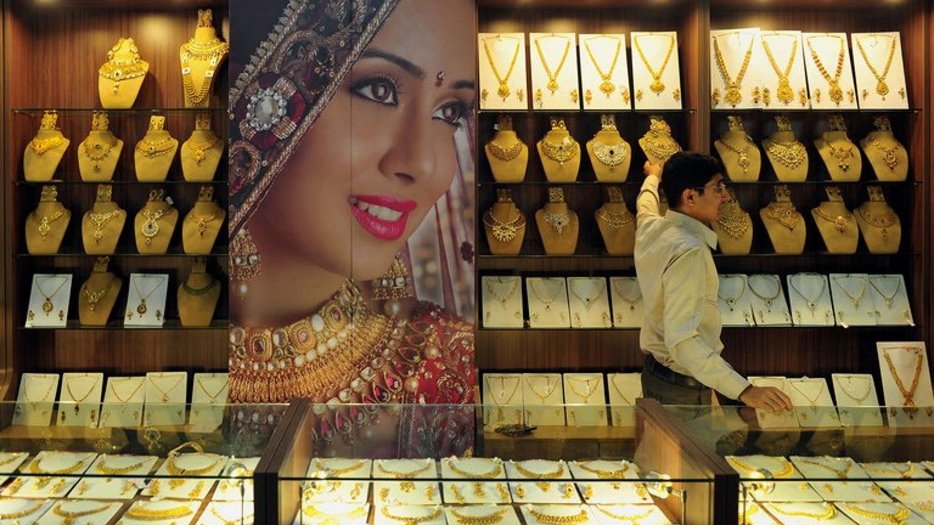 An Indian jewellery store worker pictured in Bangalore on October 14, 2011. India, the world's biggest gold-buying nation, has slapped fresh curbs on imports of the precious metal in a bid to curb a record current account deficit.