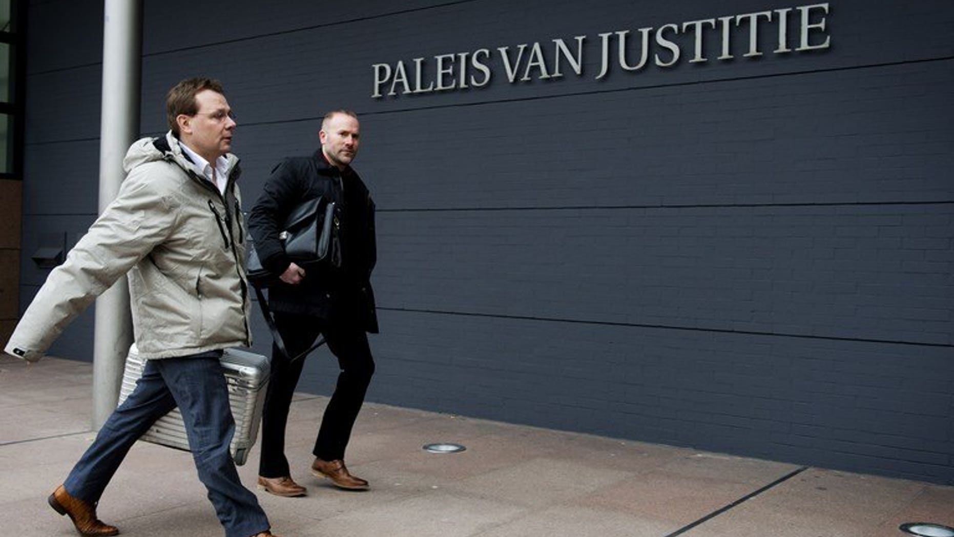 Dutch lawyer Andre Seebregt (left) arrives at a courtroom in The Hague, on February 12, 2013. Seebregt -- who represents Dutch-Pakistani Al-Qaeda suspect Sabir K -- is trying to stop his client's extradition to the United States. A Dutch court has blocked Sabir K's extradition to the US, saying there were unanswered questions about the US role in his alleged torture in Pakistan.
