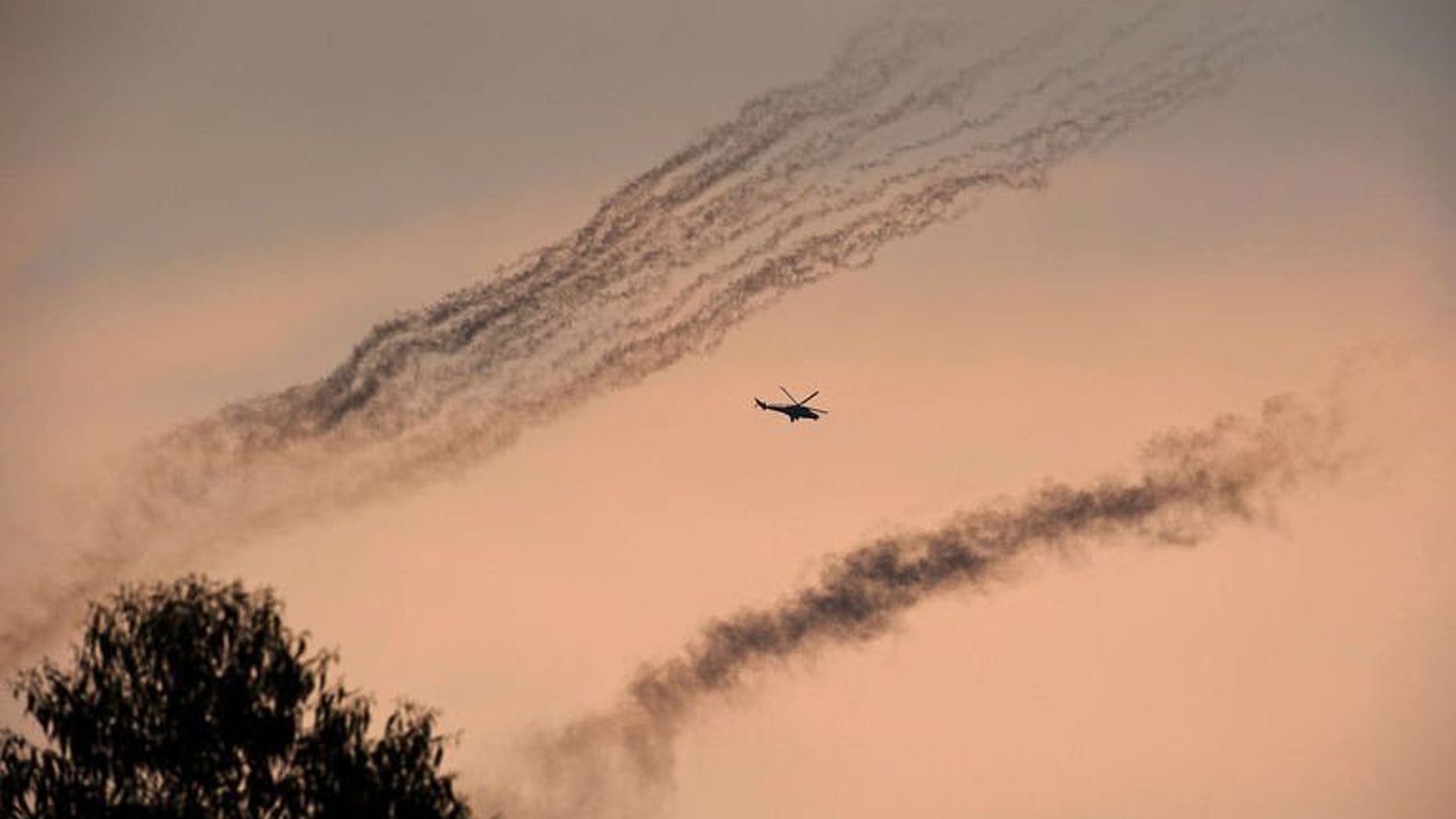 A Congolese army helicopter flies amidst smoke from rockets fired at M23 positions north of Goma in the east of the Democratic Republic of the Congo on July 17, 2013. Three Congolese army helicopters on Tuesday blasted positions of the rebel M23 movement near the eastern Democratic Republic of Gongo (DRC) provincial capital of Goma.