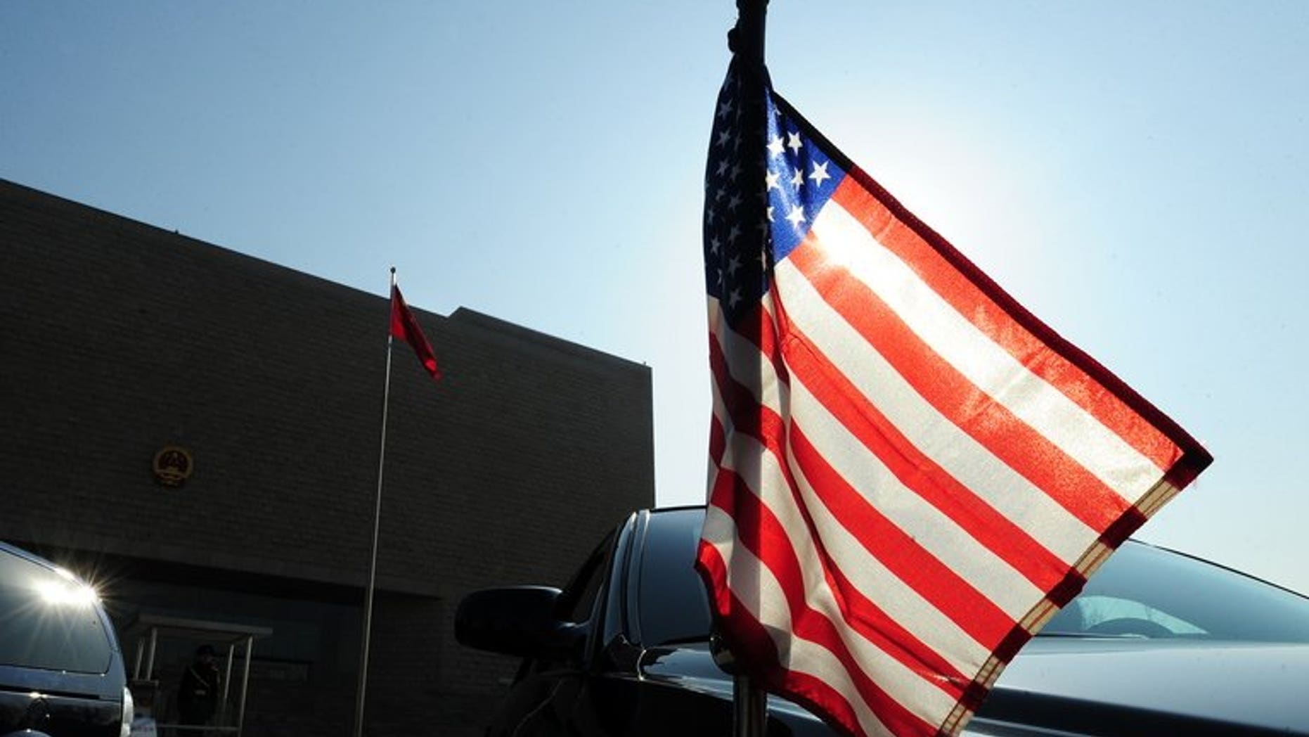 The US embassy vehicle carrying Ambassador Jon Huntsman leaves the Supreme People's Court in Beijing on February 18, 2011. An American has been detained in China, a US embassy official says, as Chinese authorities continue a probe into corruption by multinational pharmaceutical companies.