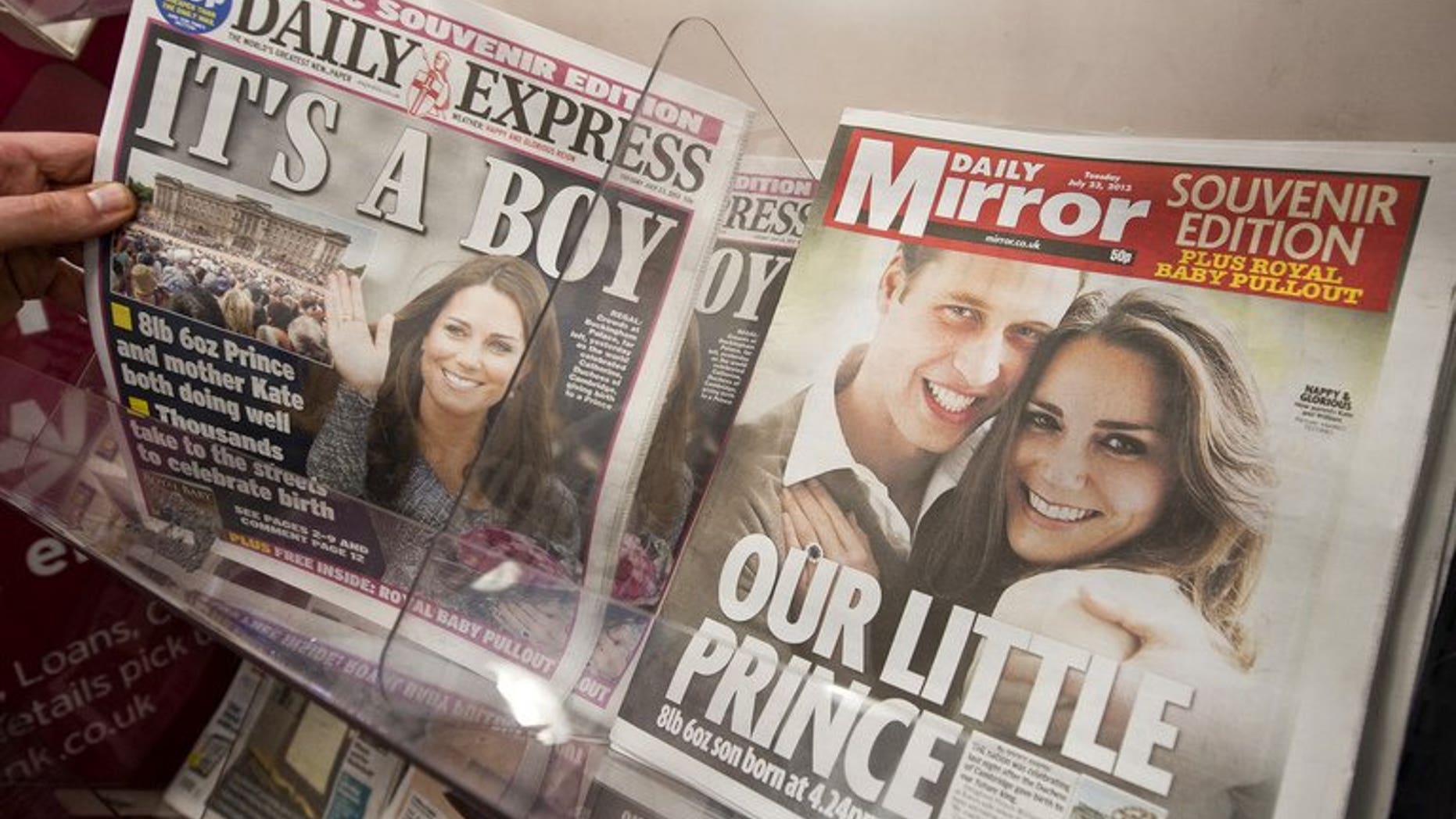 Newspaper front pages report news of the birth of a new royal baby in London on July 23, 2013.