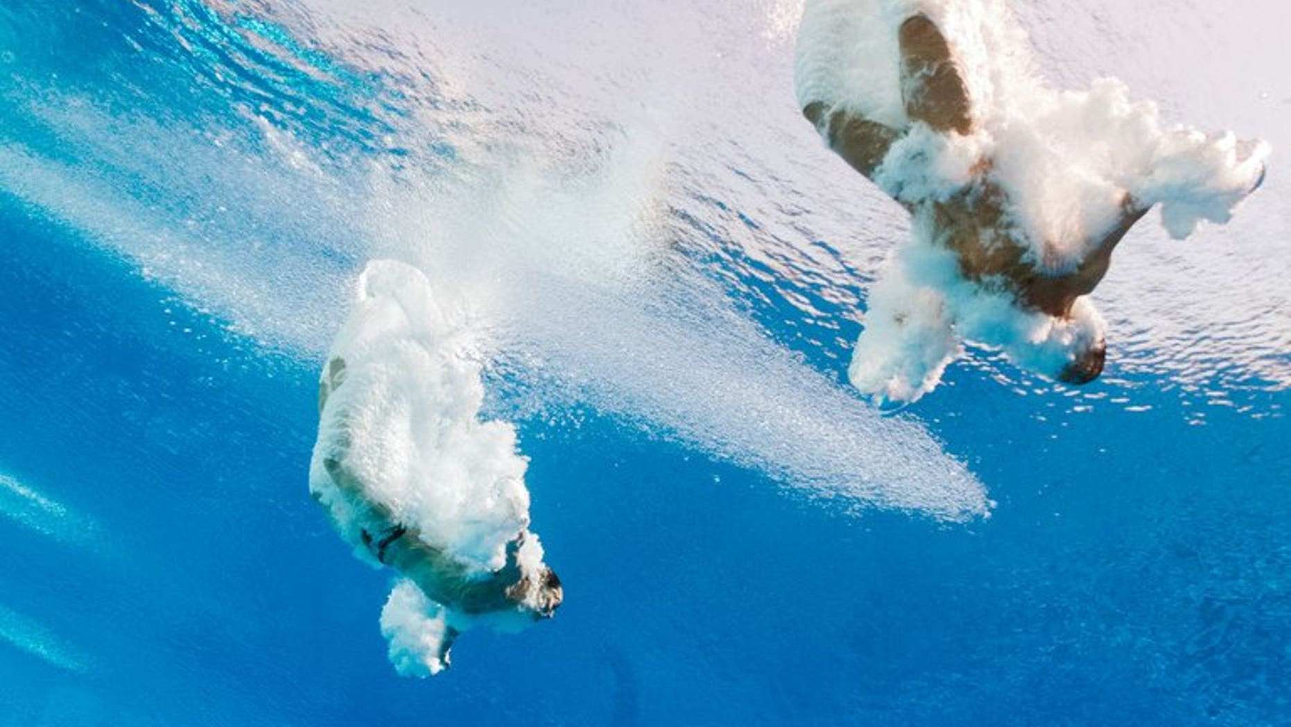China's Qin Kai and He Chong compete in the men's 3-metre synchro springboard preliminary diving event in the FINA World Championships at the Piscina Municipal de Montjuic in Barcelona on July 23, 2013. Qin recorded his fourth consecutive world championship win in the 3m synchronised springboard as he and partner He proved far too strong for the rest of the field.