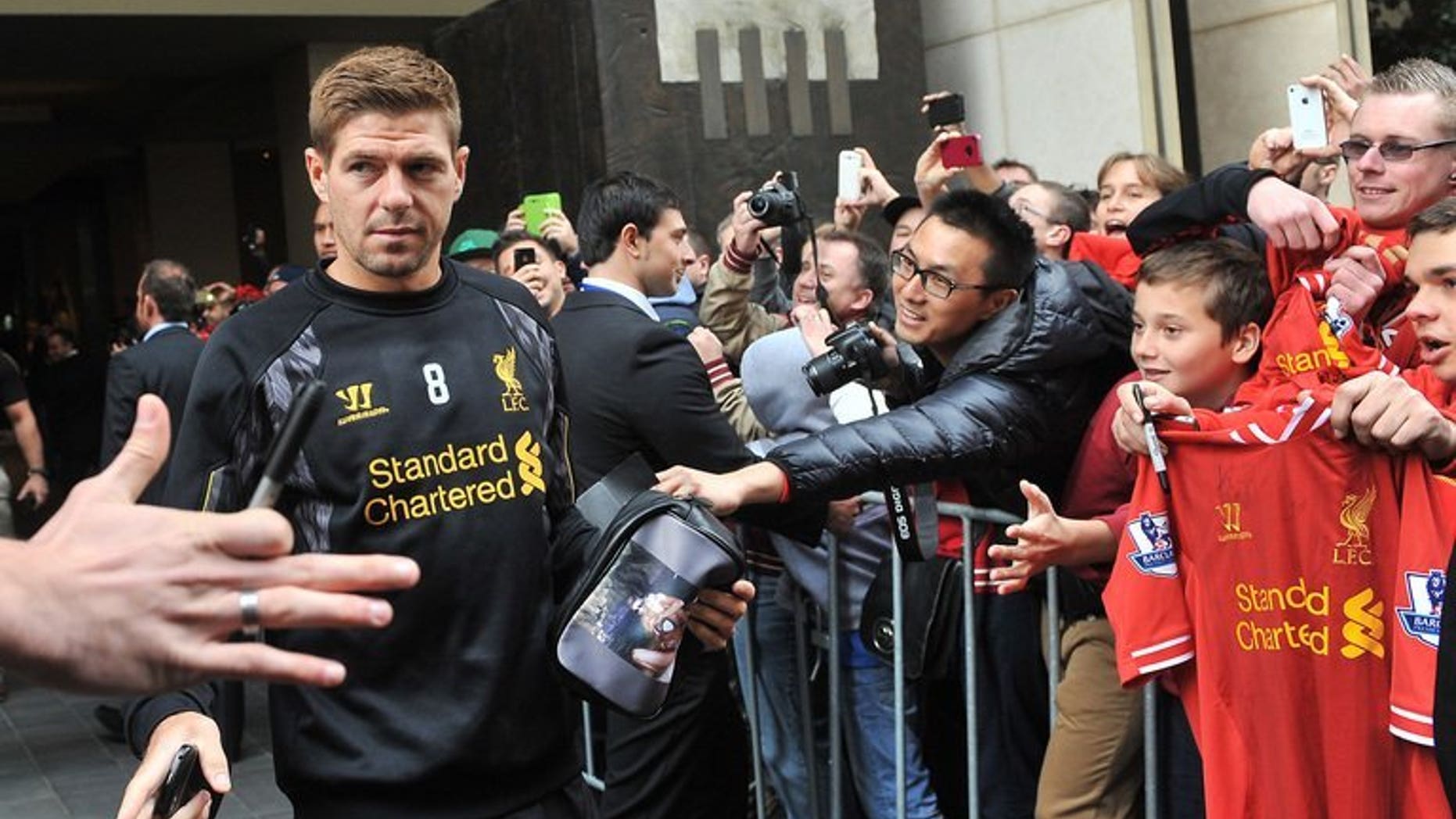 Liverpool midfielder Steven Gerrard acknowledges fans as the team leaves their hotel for a training session in Melbourne on July 22, 2013. Gerrard said Wednesday he believes success is just around the corner for the Merseyside club, and urged the team's owners to keep backing manager Brendan Rodgers.