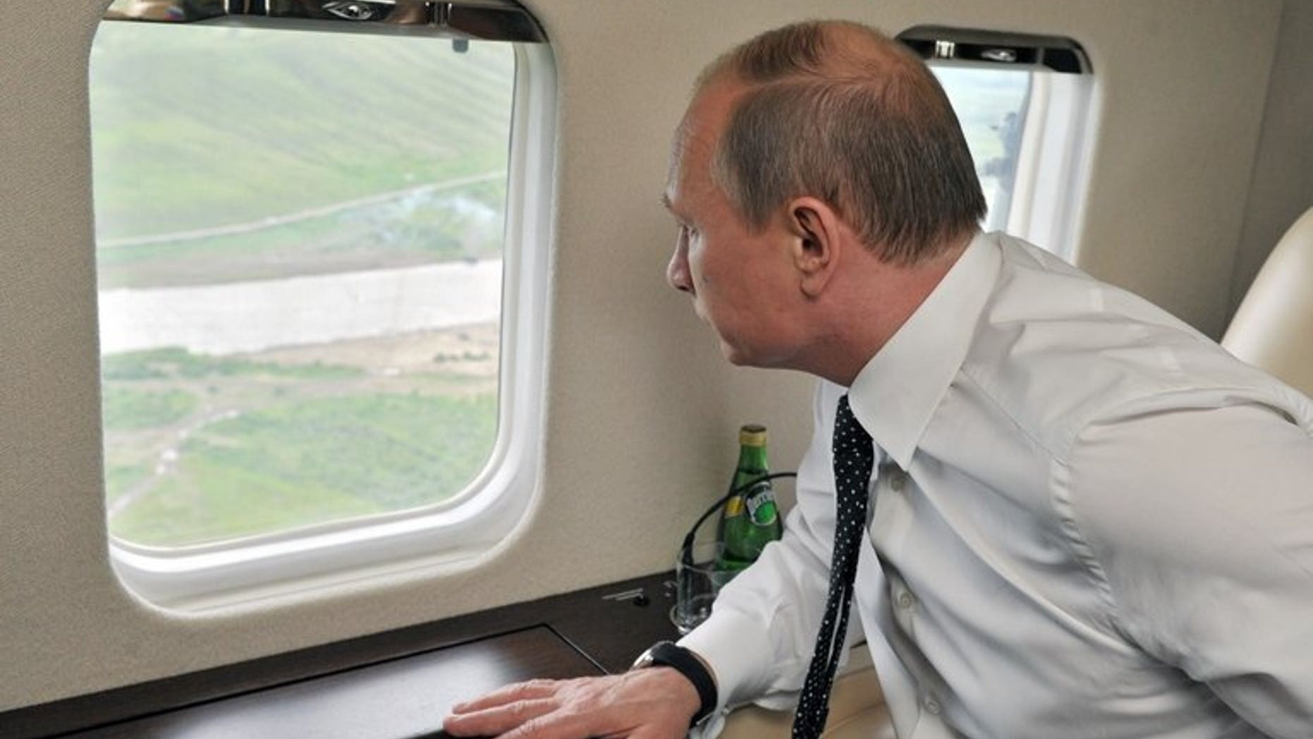 Russian President Vladimir Putin watches military exercises from a plane near the eastern Siberian city of Chita on July 17, 2013. President Vladimir Putin is to visit Iran in August to try and restart talks on Tehran's controversial nuclear programme, Russia's Kommersant daily reported on Wednesday.
