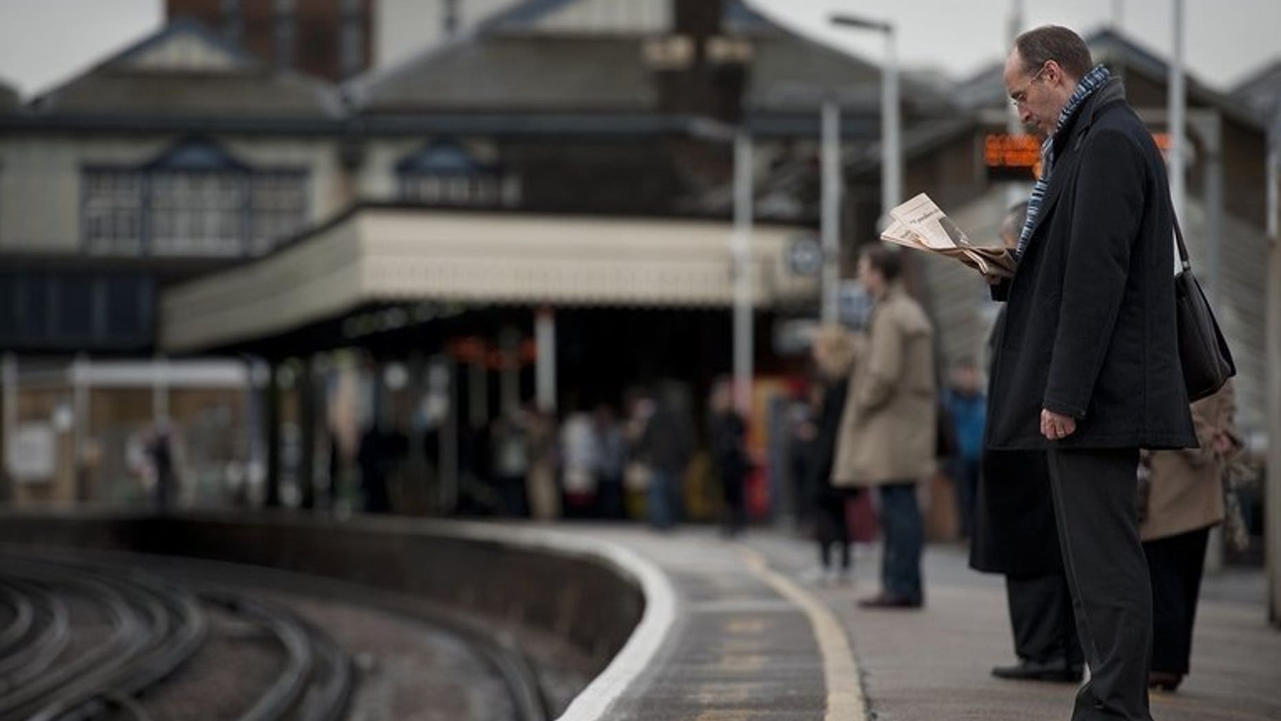 File picture taken on January 19, 2012 shows rail passengers waiting for a train on the platform at Clapham Junction station in south London. The latest challenge to the government's plans for the HS2 national high-speed rail project was rejected on Wednesday by the Court of Appeal.