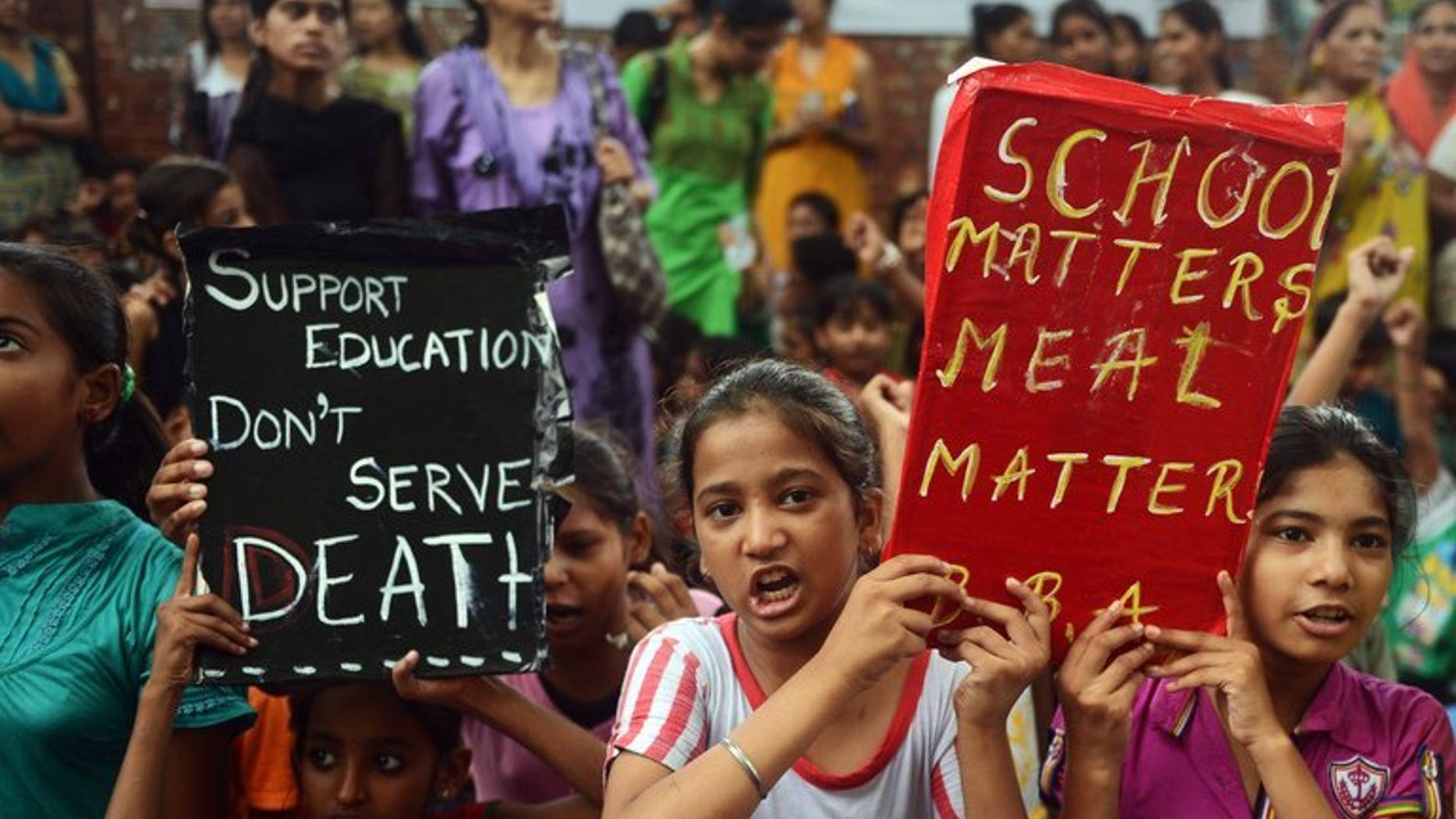 Indian children and activists shout anti-government slogans during a rally in New Delhi, on July 20, 2013. The rally was called following the death of 23 children in Bihar state after they ate poisoned school meals. Indian police have arrested the head of a school in eastern India where 23 students died after eating food tainted with pesticide, an officer told AFP.