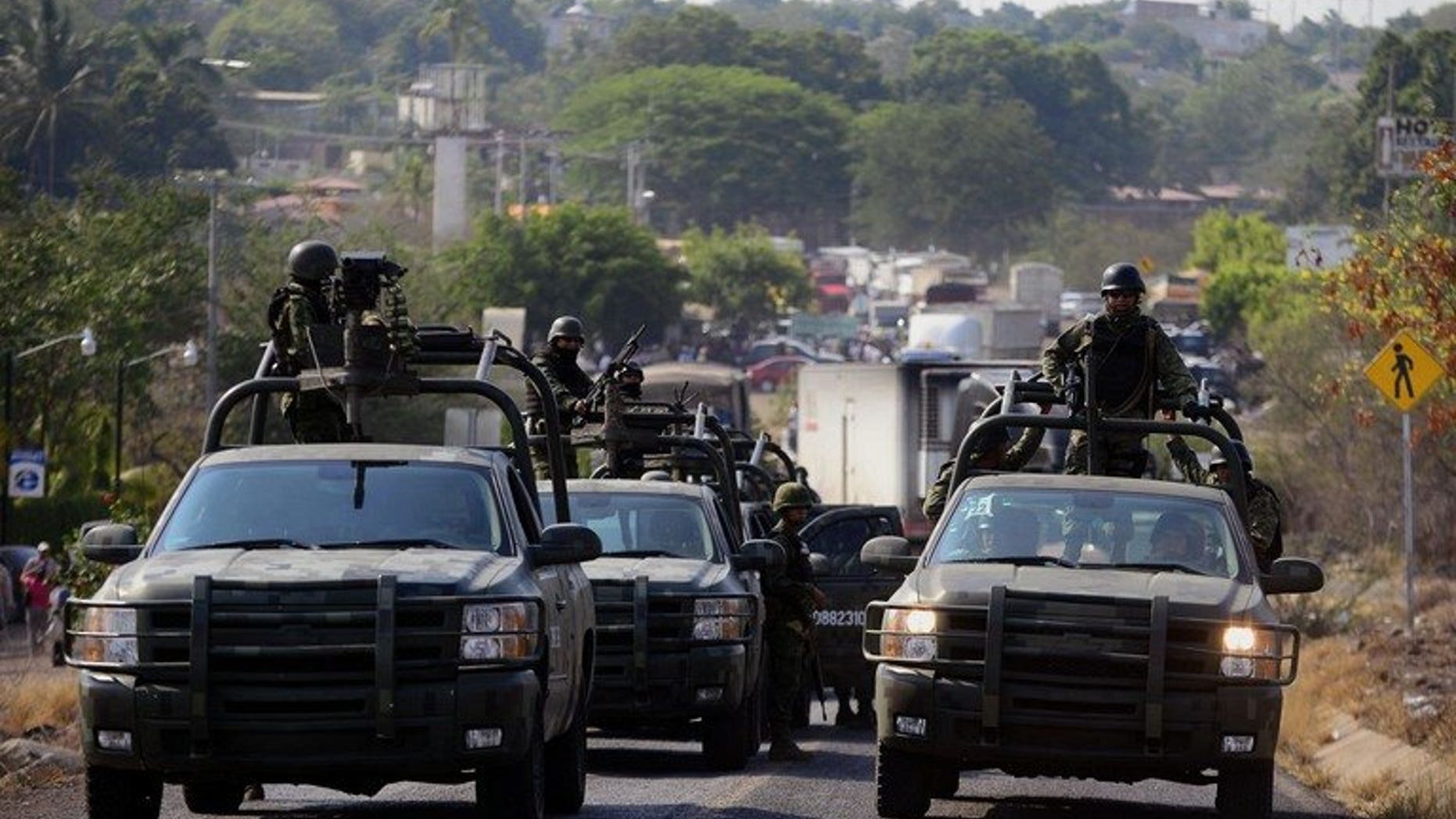 Soldiers of Mexican Army patrol in Michoacan State, Mexico on May 22, 2013. Security forces in the Mexican state plagued by drug violence were working to restore order on Wednesday after clashes which left 22 dead.