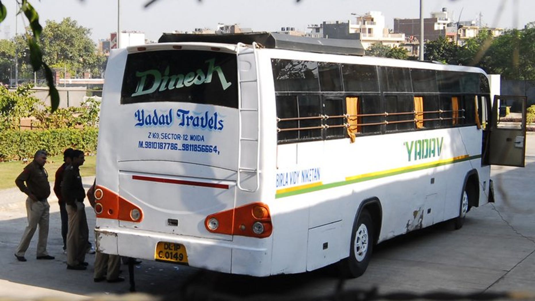 In this photograph taken on December 18, 2012, Indian policemen inspect an impounded bus, suspected to be the vehicle where five men and a youth gang-raped a student while driving around the city, at the Thyagaraj Stadium in New Delhi. An Indian court is expected to deliver the first verdict this week on one of five suspects tried over the fatal gang-rape.