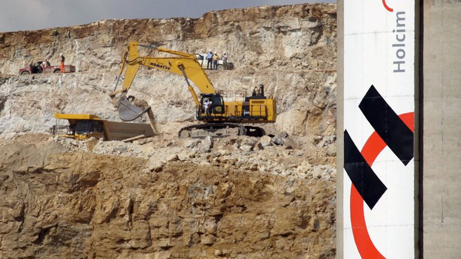Workers are seen at a quarry of Swiss company Holcim in 2007, in Eclepens. Shares of India's Ambuja Cements and ACC slumped Thursday after their parent company, Holcim, announced a restructuring of Indian operations aimed at lowering costs.