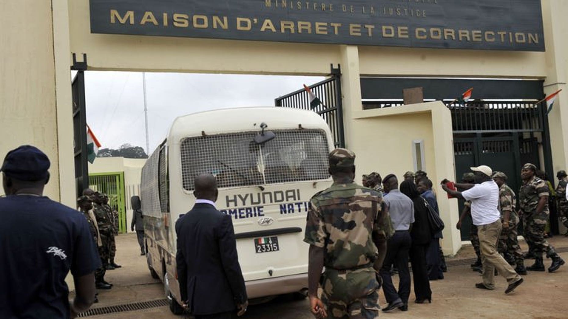 A police van enters the gates of the Maca prison in Abidjan, Ivory Coast, on August 16, 2011. At least six prisoners have died and several others, including guards, were injured during an attempted breakout from the jail, security sources say.