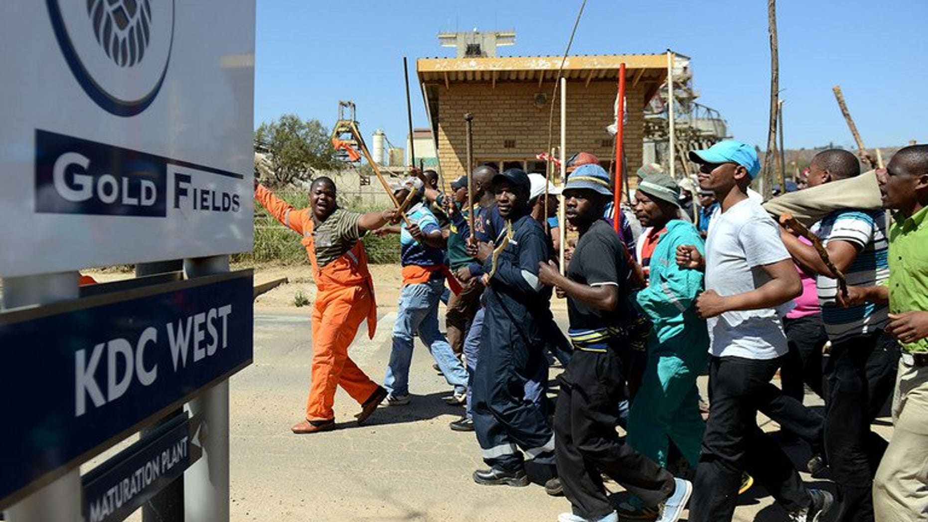 Striking Gold Fields mine workers march on September 11, 2012 in Carletonville, west of Johannesburg. Gold miners have vowed to take their silicosis lawsuit against London-listed Anglo American to South Africa's courts, after a British court refused to hear their case.