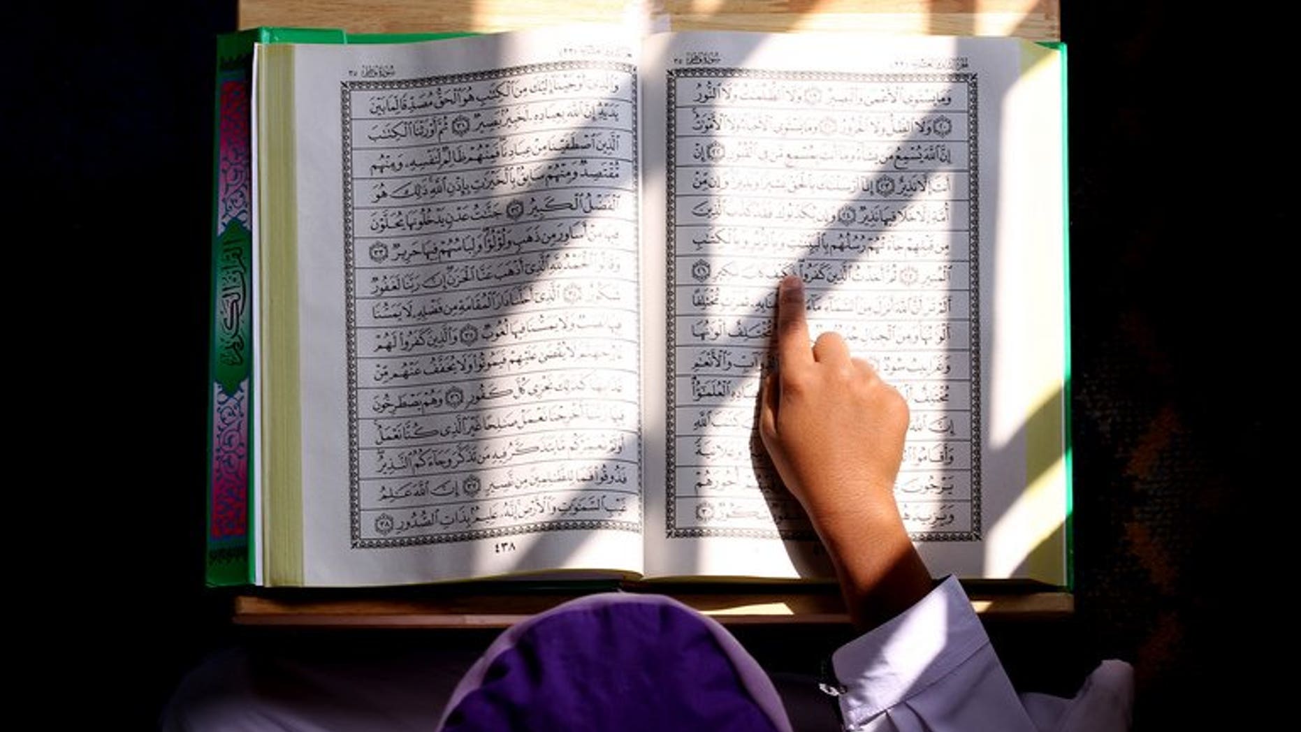 A Malaysian Muslim boy reads from the Koran inside a mosque in Kuala Lumpur on July 31, 2011. A Malaysian court on Thursday ruled against the 2009 conversion of three Hindu children to Islam without their mother's knowledge, a verdict welcomed by non-Muslim groups.