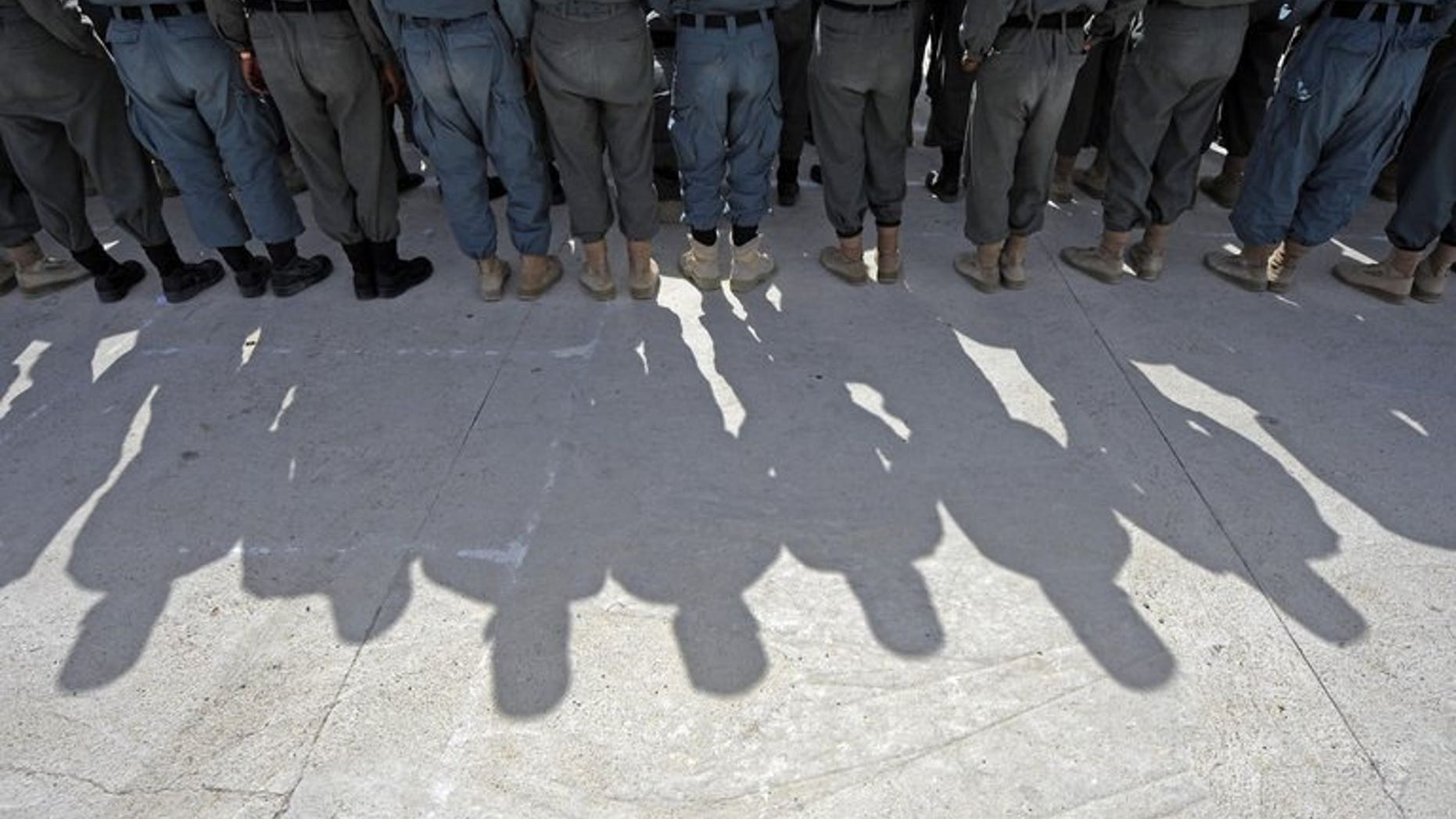 In this photo provided by ISAF Regional Command (South), Afghan police graduates stand in formation at the Qalat Police Training Centre in the Zabul province, Afghanistan, April 7, 2011. The Taliban poisoned and captured at least 12 policemen as they broke their fast during the holy Muslim month of Ramadan in an attack in Zabul province, officials said Thursday.