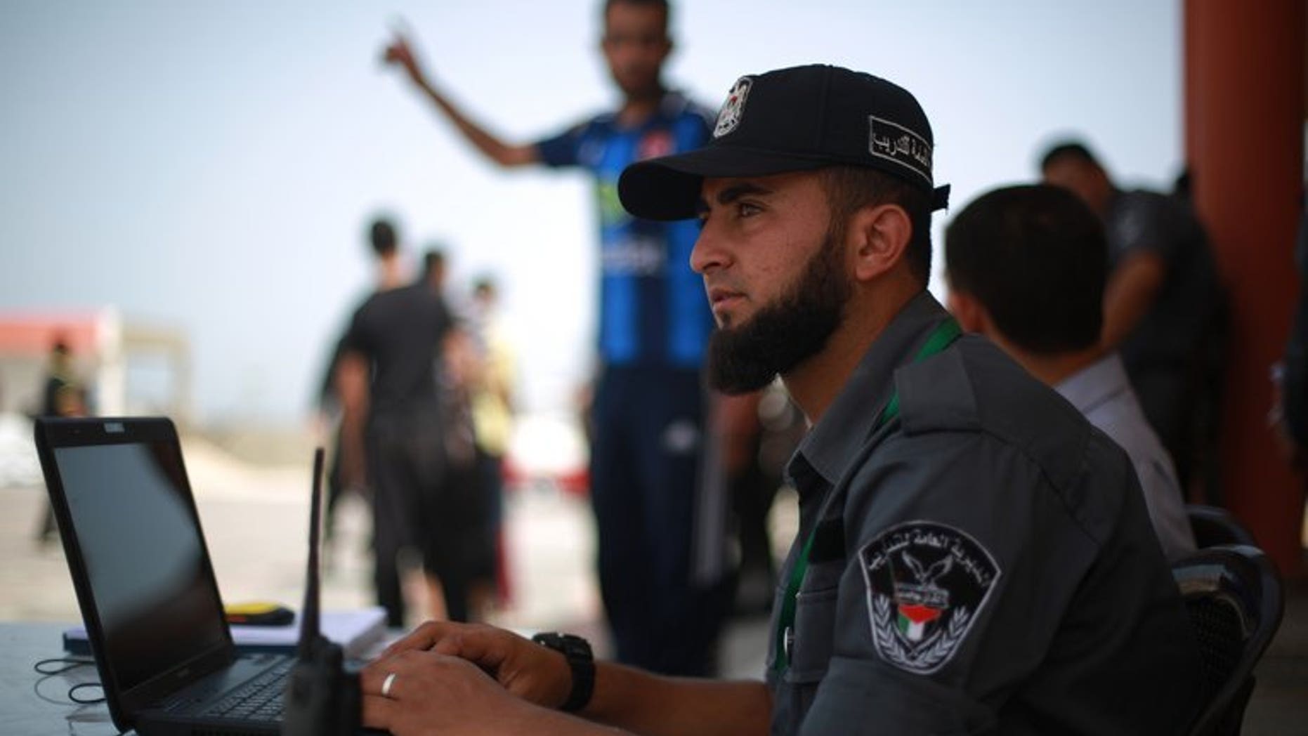 A Hamas policeman sits at his laptop in Gaza City on June 2, 2013. Authorities in the Hamas-ruled Gaza Strip on Thursday closed local offices of Al-Arabiya TV and Palestinian news agency Maan for alleged "false" reporting of Hamas help for Egypt's Muslim Brotherhood.