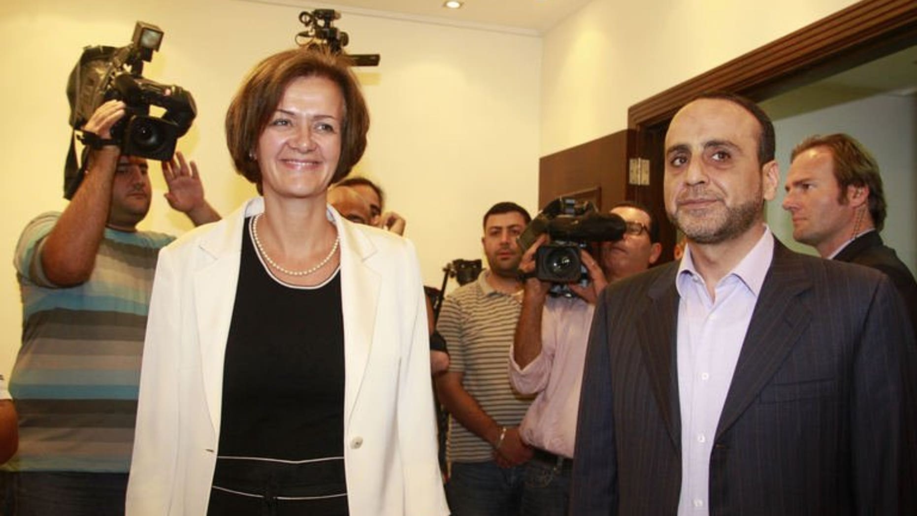 Ambassador of the European Union to Lebanon, Angelina Eichhorst (L) and head of Hezbollah's International Relations, Ammar al-Mussawi leave after a meeting following European Union's decision to blacklist Hezbollah's armed wing on July 25, 2013 in the Lebanese capital Beirut.