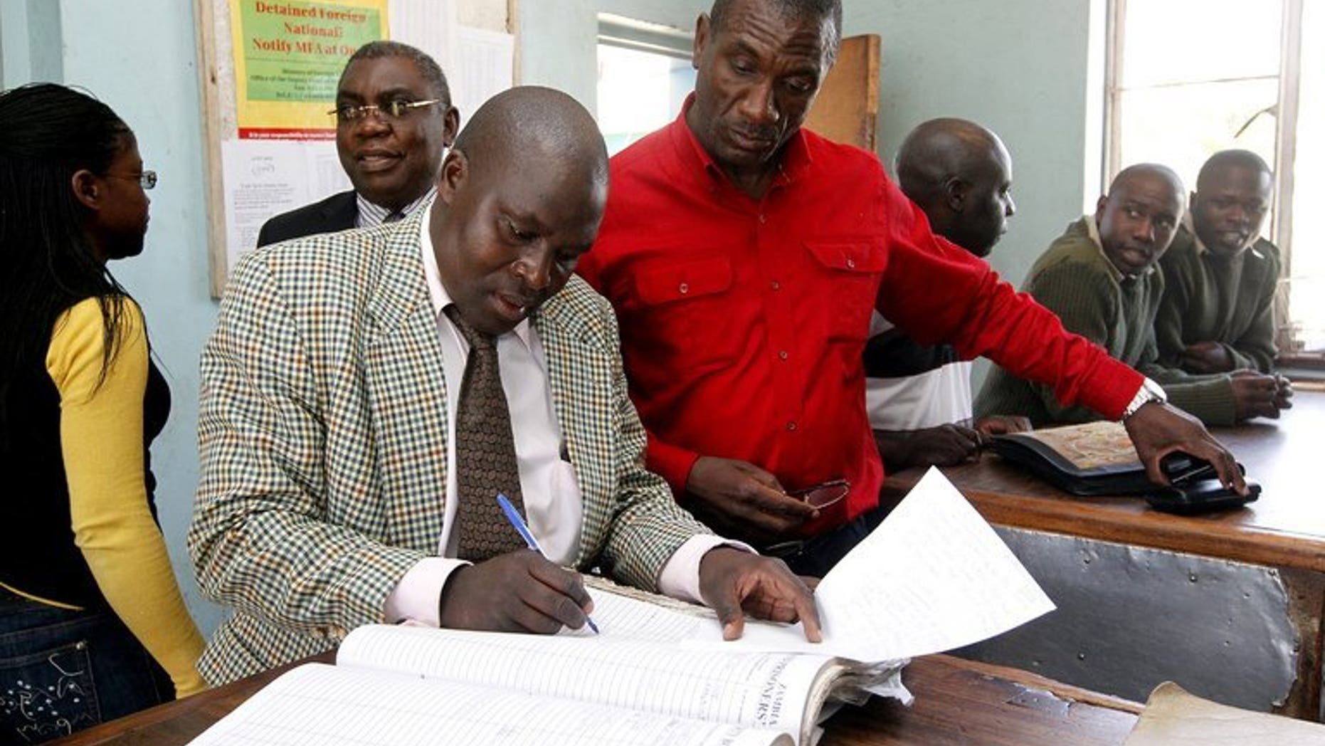 Former Zambian President Rupiah Banda's son Andrew (4th R) leaves Woodlands Police Station on May 31, 2012 in Lusaka. Andrew Banda was arrested Thursday on charges of defaming his father's successor, his lawyer says.