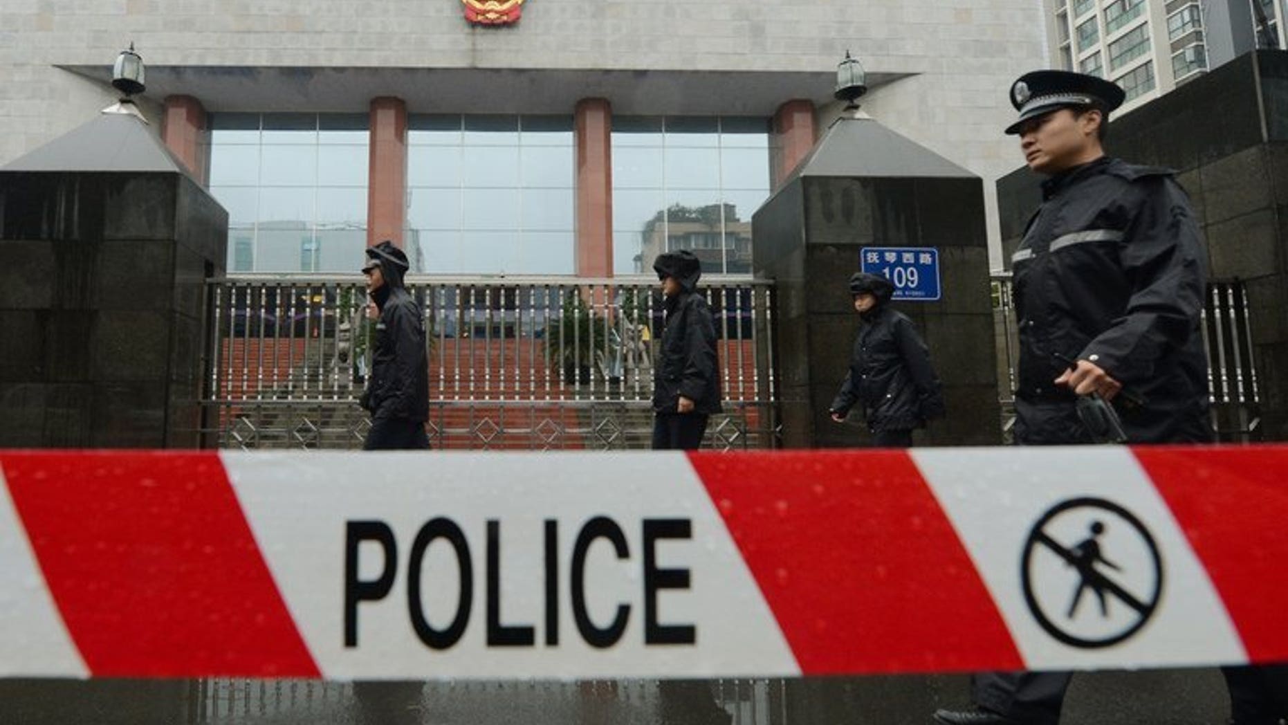 File image shows a policemen on guard outside the Chengdu People's Intermediate court in Chengdu, southwest China's Sichuan province, on September 24, 2012. A knife-wielding Chinese man has stabbed five people to death and wounded another three in the central Henan province, state media reported Friday.