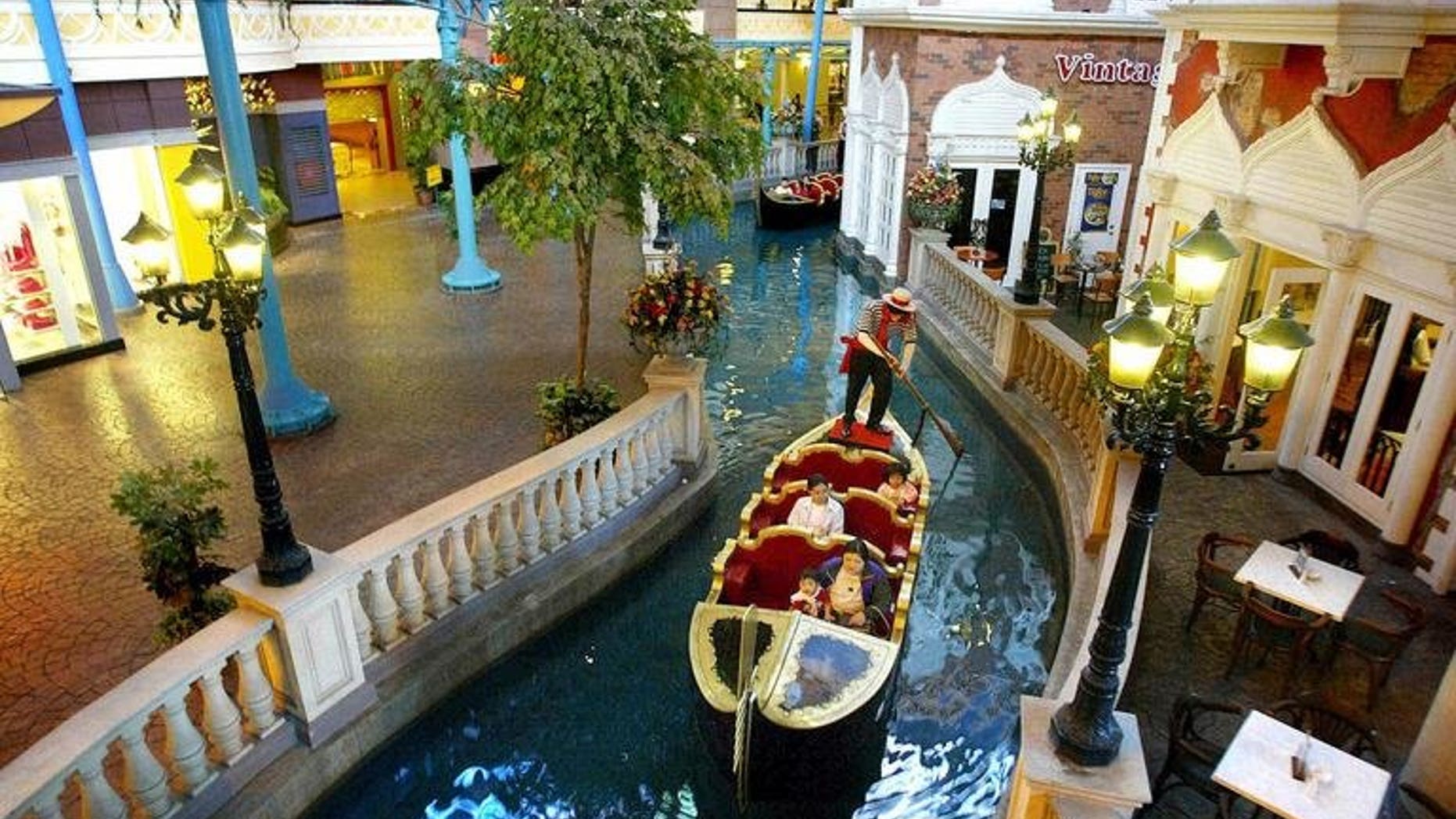 A Venician gondola carries visitors in a mini river at the new First World Plaza in Genting Highlands, north of Kuala Lumpur, on July 27, 2002. Malaysian casino operator Genting's resort unit will build a 400 million ringgit ($125 million) Twentieth Century Fox Theme Park near the capital Kuala Lumpur.