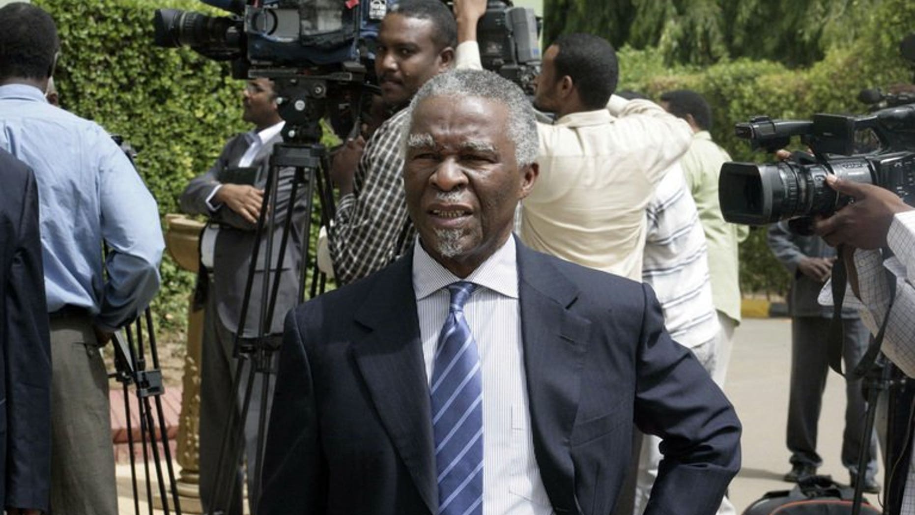 South Africa's former president Thabo Mbeki walks past journalists as he leaves after a meeting with Sudanese president on July 25, 2013 in the Sudanese capital, Khartoum. He was part of securing a deal for Sudan to delay closing an economically vital pipeline carrying South Sudanese oil.