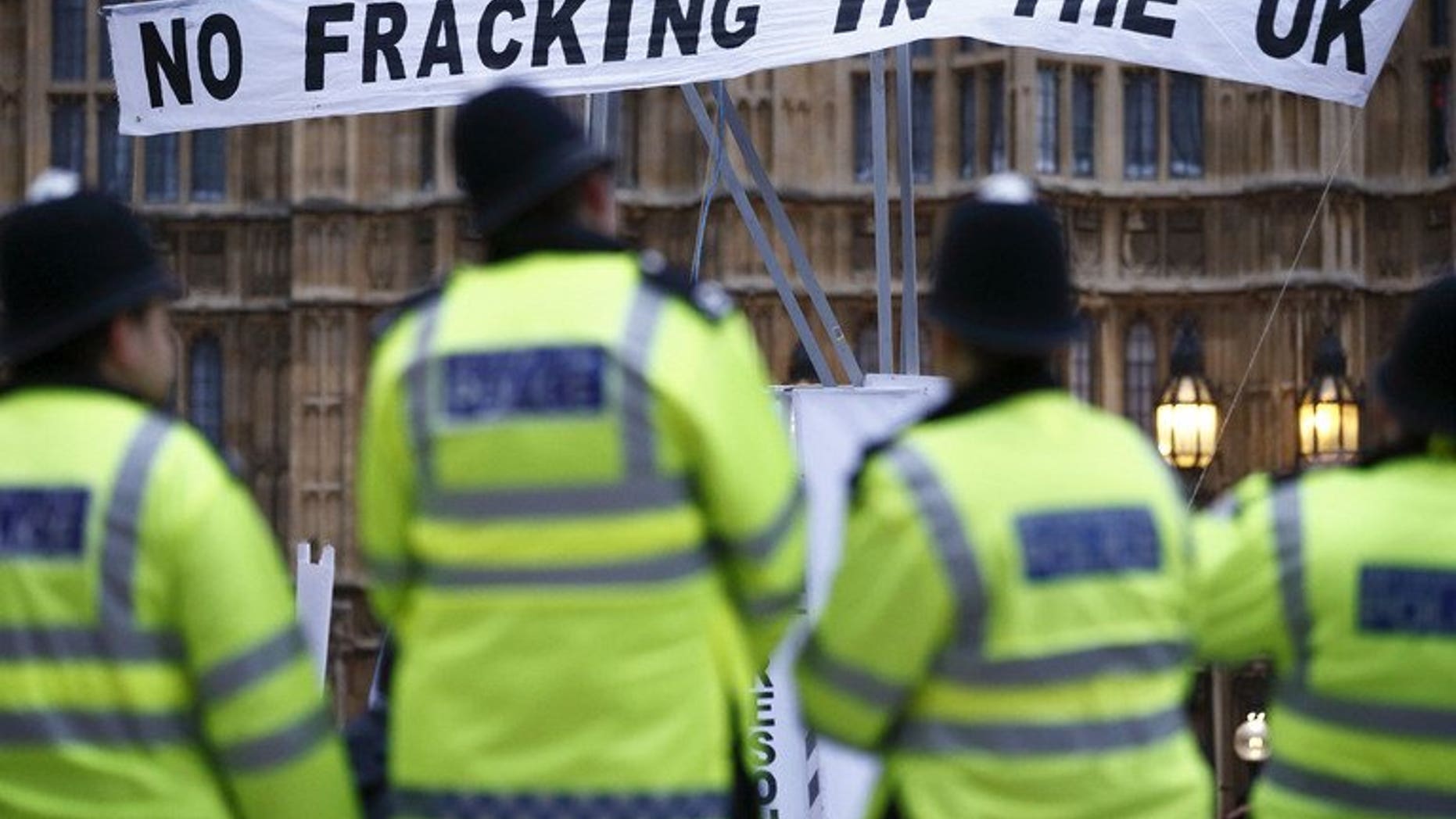 British police secure the area near protesters against fracking in London on December 1, 2012. Sixteen protesters were arrested as police broke up a blockade against exploratory drilling by a fracking company in southern England.