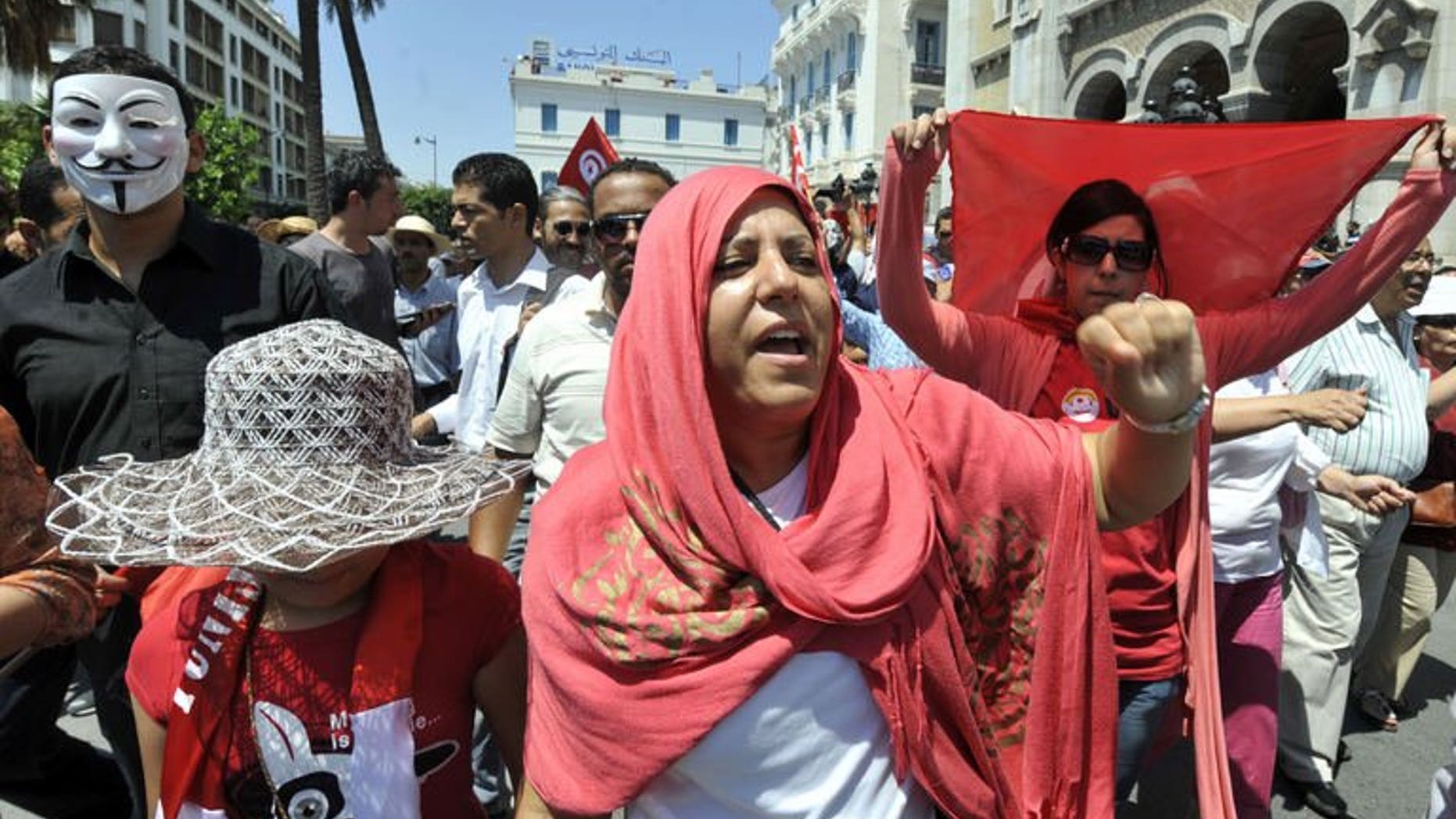 Tunisian protesters shout slogans during an anti-government demonstration on July 26, 2013 in Tunis after the killing of the opposition politician Mohamed Brahmi. A demonstrator was killed in the central Tunisian town of Gafsa overnight during a march protesting the assassination of Brahmi.