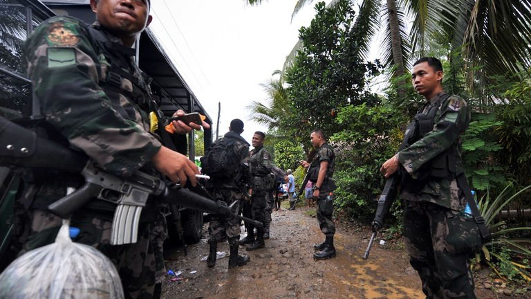 This file photo shows members of a police special action force manning a checkpoint on the southern Philippine island of Mindanao, on December 12, 2009. Six people were killed and more than two dozen wounded when a bomb exploded at a restaurant in a town on Mindanao late on Friday, July 26, 2013.