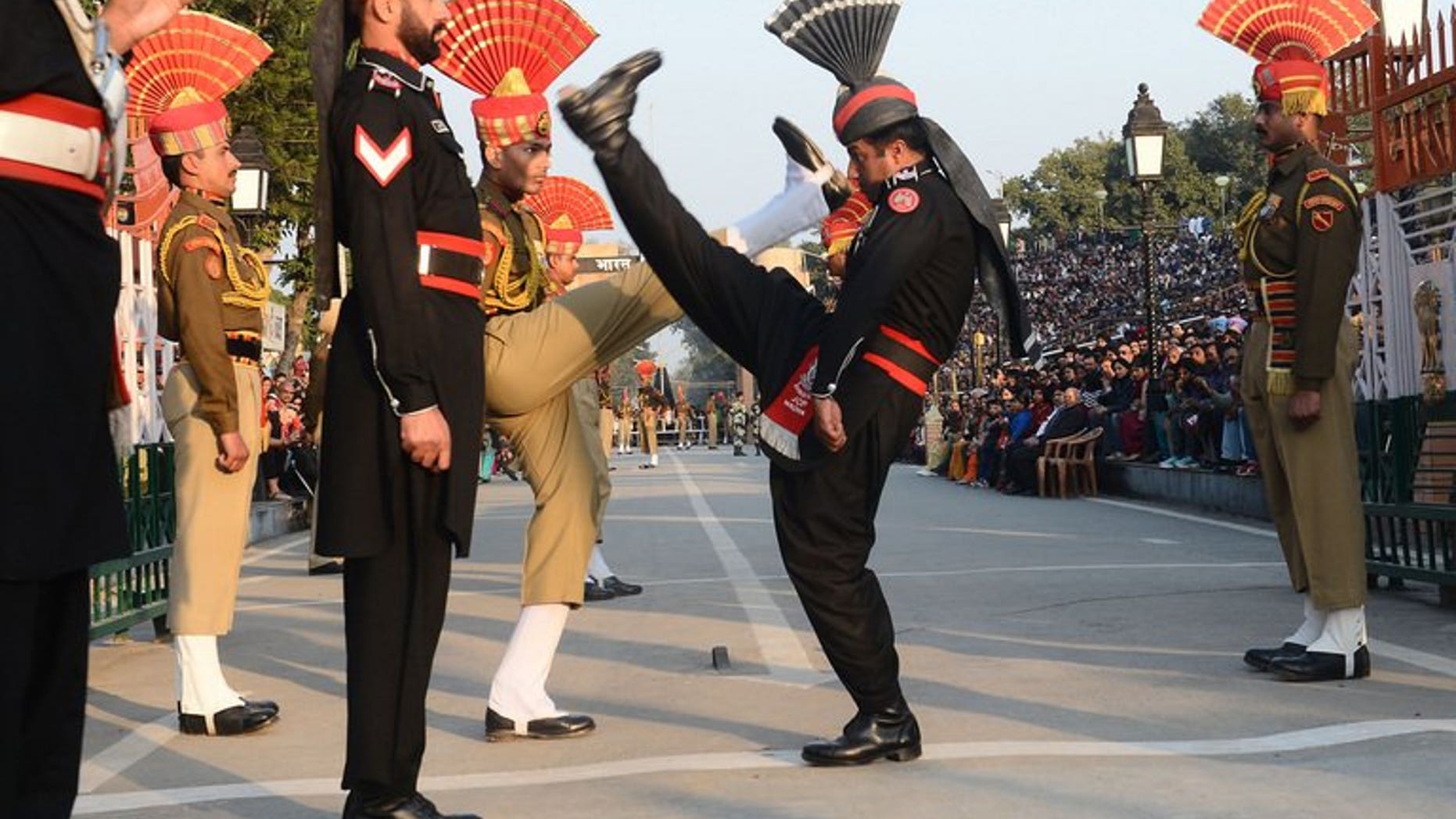 Pakistani (in black) and Indian border troops perform the 'flag off' ceremony at Wagah border post. Indian troops shot and killed one Pakistani soldier and injured another in an "unprovoked" attack across the countries' disputed border in Kashmir, Pakistan's army said Saturday.