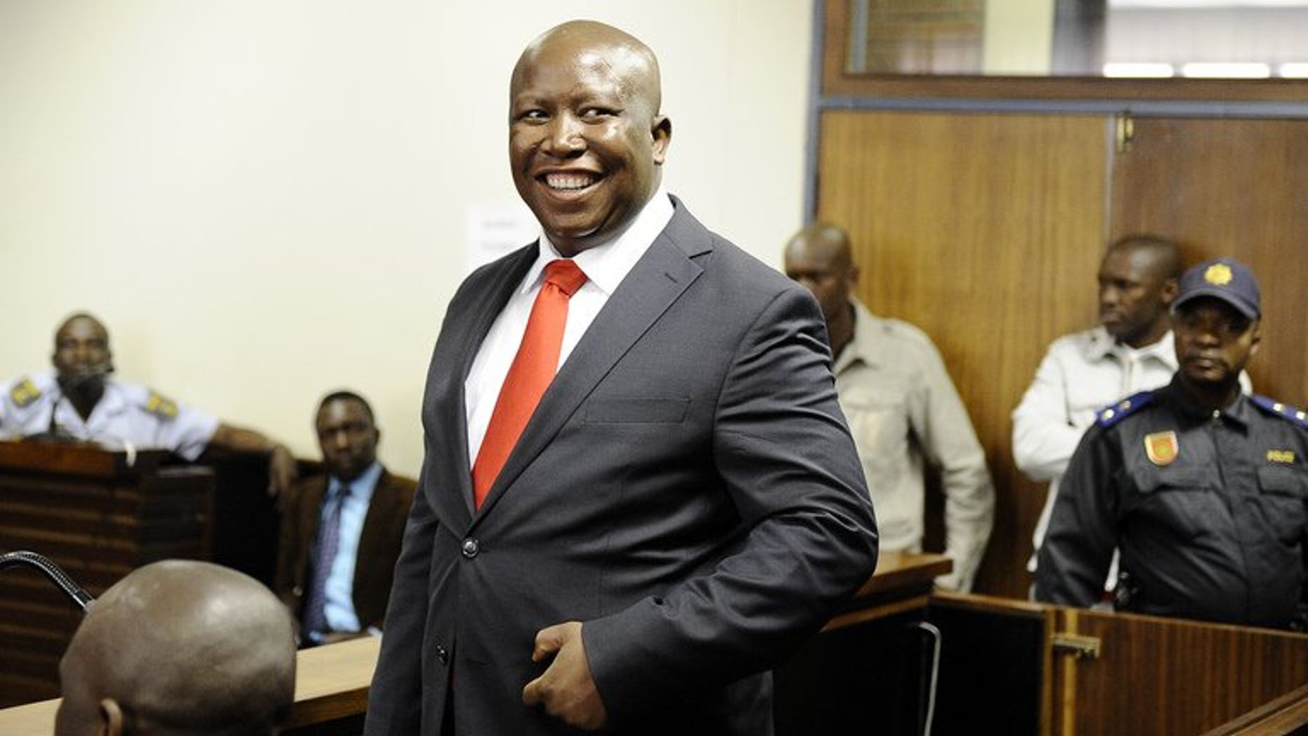 South African populist firebrand Julius Malema smiles as he arrives in court on September 26, 2012 in Polokwane. Malema launched South Africa's newest political party Saturday to take on his former party, the ruling African National Congress (ANC), in polls next year.