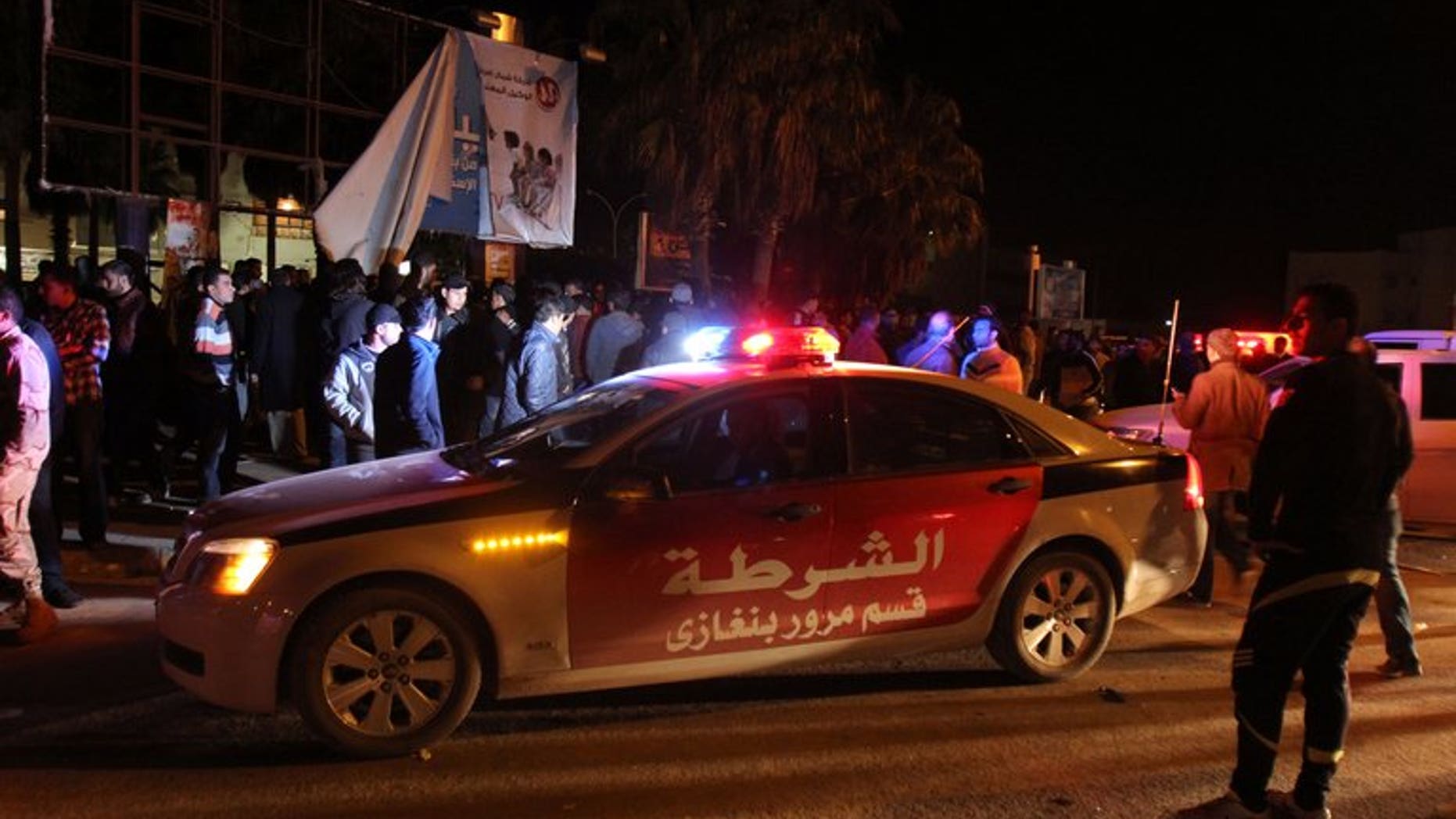 Libyans and police gather on January 14, 2013 in a central neighbourhood of Benghazi. More than 1,000 inmates escaped during a prison riot and attack on Saturday in the unruly Libyan city of Benghazi, a security official told AFP.