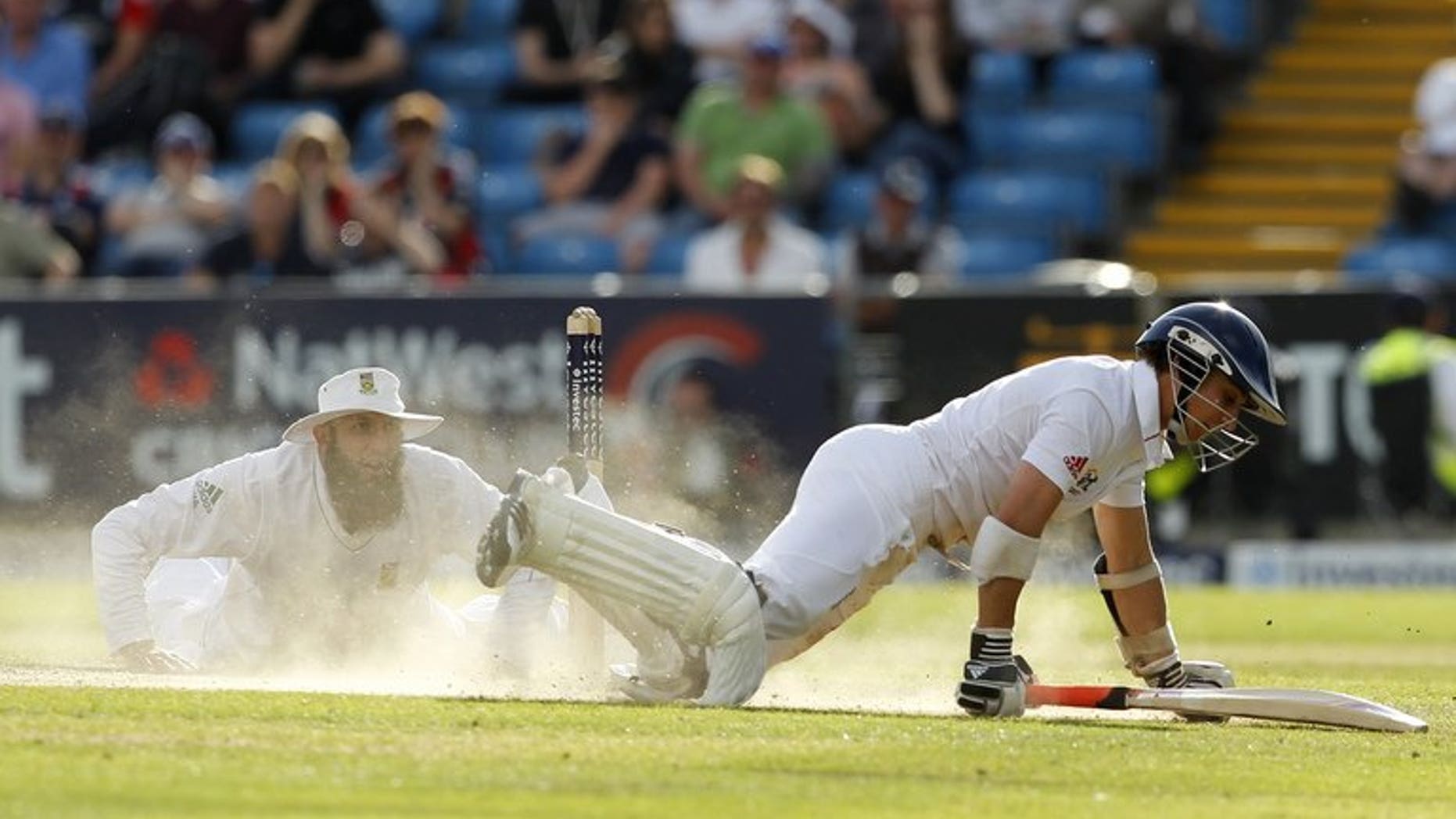 England's James Taylor (R) dives to avoid a run on August 4, 2012. He advanced his case for an England recall by making an unbeaten 64 for Sussex against Australia on the second day of three at Hove.