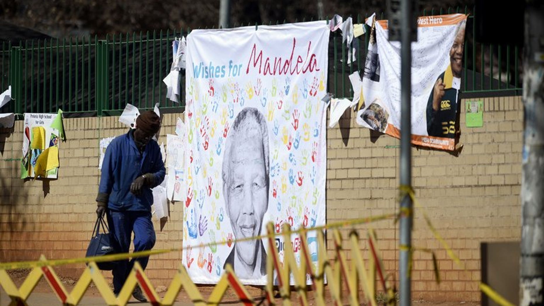 A banner with well-wishing messages left for former South African president Nelson Mandela, on July 19, 2013, outside the Pretoria hospital where he is in a critical condition. South Africa's presidency declined to comment on a report the anti-apartheid hero had undergone an operation.